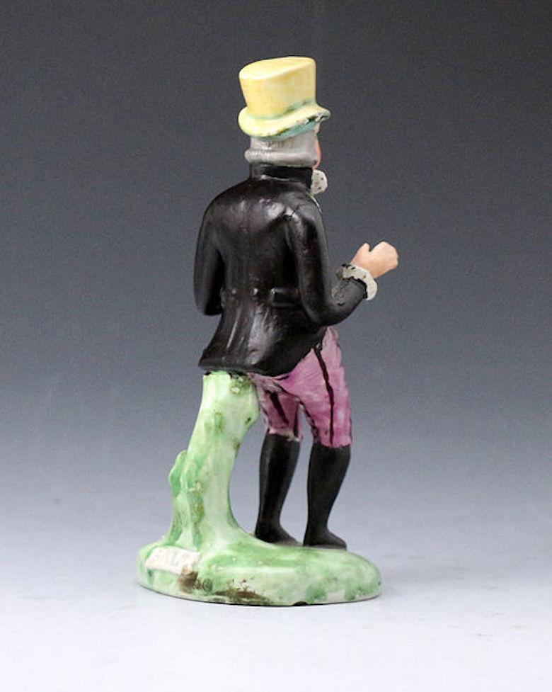 Dated: 1820 Staffordshire England

A fine Staffordshire pottery pearlware theatrical figure of Paul Pry with the title I HOPE I DON'T INTRUDE impressed in the base in black capitals. 
This quality figure is well modelled standing on green