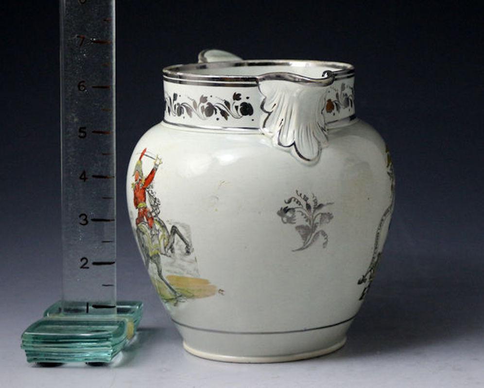 Dated: 1815 Staffordshire

English pearlware glazed pottery pitcher with silver luster decoration. The pitcher features two images, one of Masonic interest with the title God is our Guide, and the other side features a Miltary Horseman brandishing