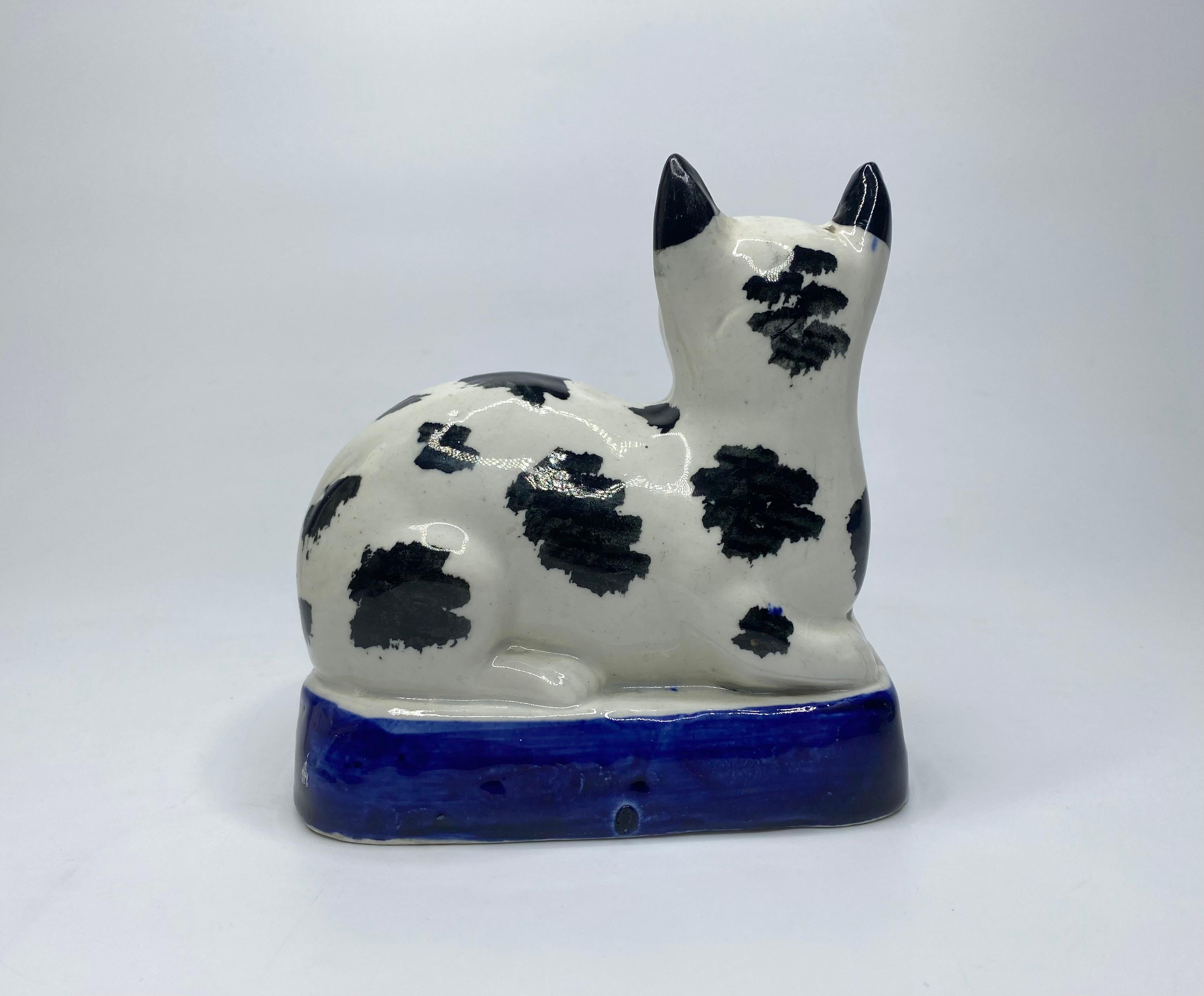 Victorian Staffordshire pottery recumbent cat, c. 1850. For Sale