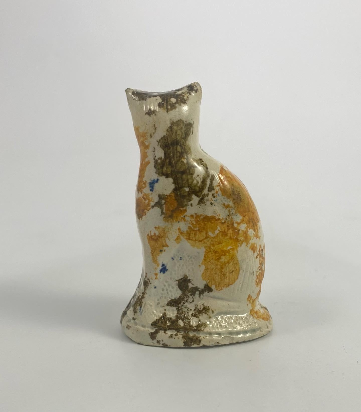 Staffordshire pottery cat, c.1800. The seated cat, with his tail curled in front, coloured in Pratt type glazed spots. Set upon an oval mound base.
Height: 7.5 cm, 3”
Width: 5 cm, 2”.
Depth: 3.5 cm, 1 3/8”.
Condition: Excellent. No damage. No