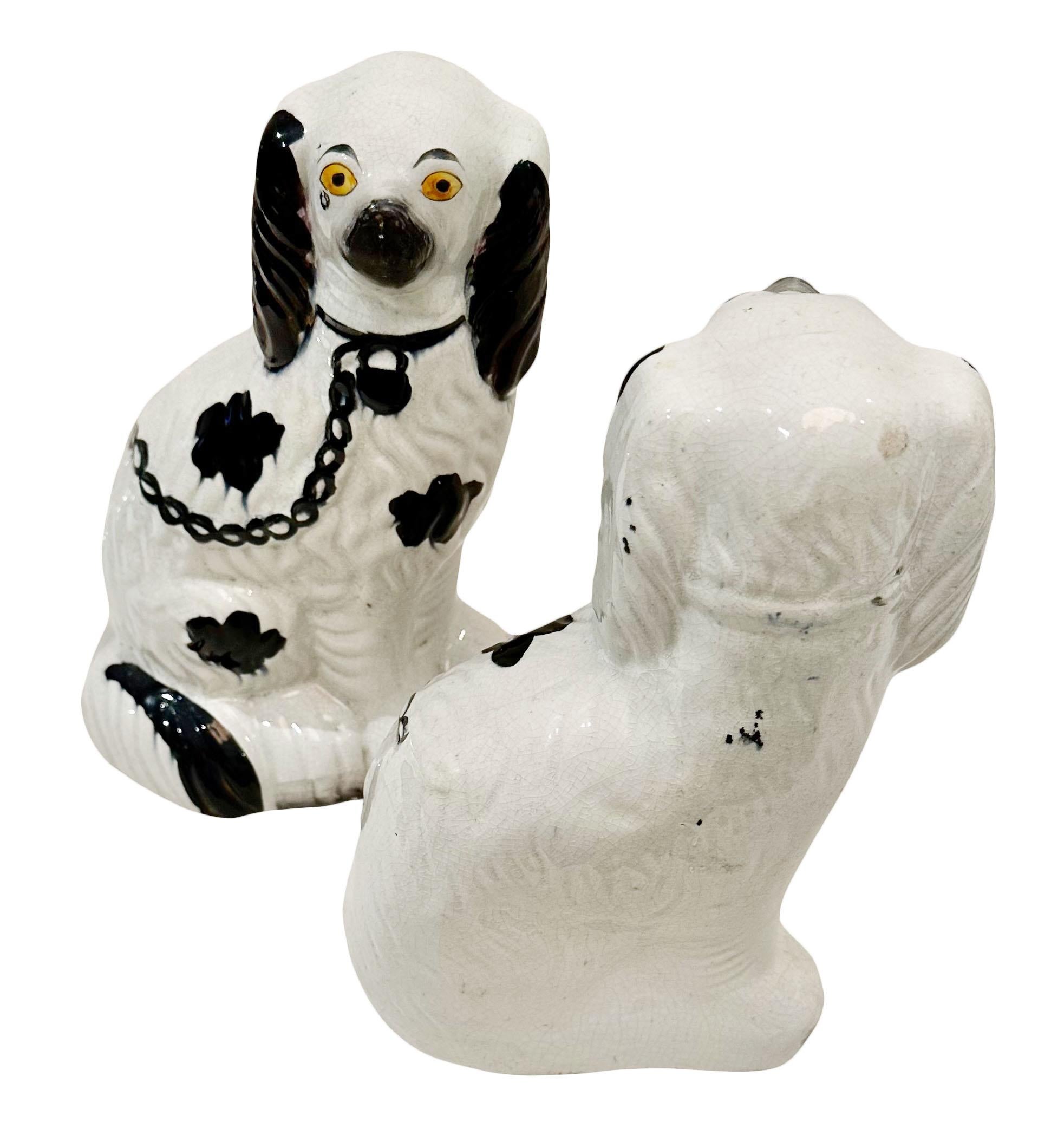 A pair of English Staffordshire spaniels in white with black spots. They are late 19th century and with wonderful color.  