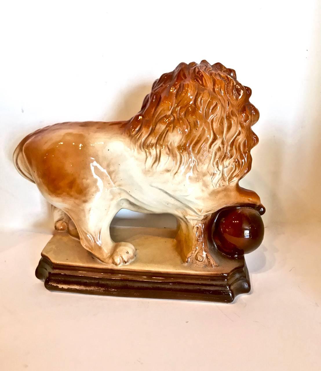 This is a good example of a standing lion with ball under right paw. The lion is in very good to excellent overall condition.