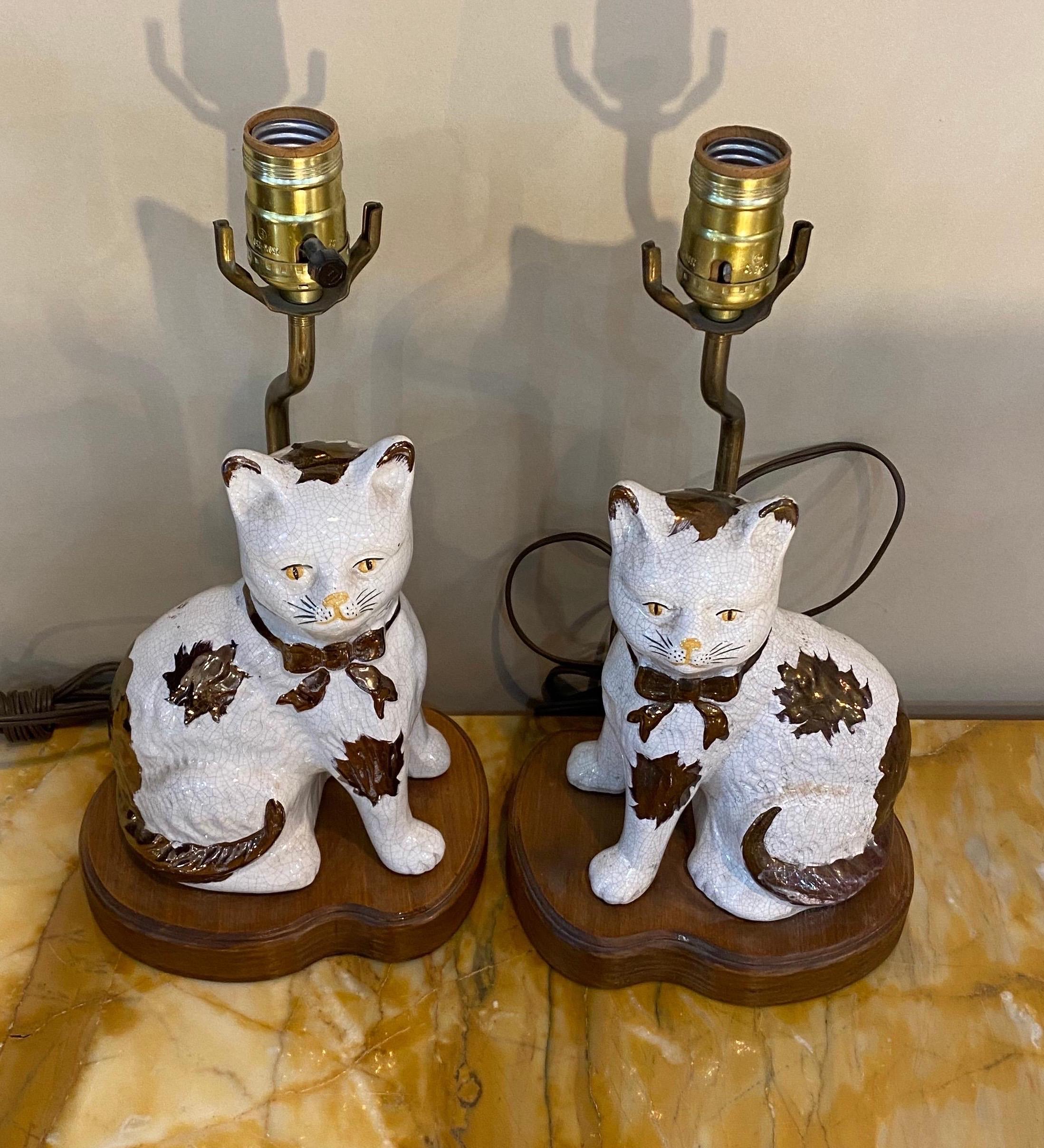 Staffordshire style porcelain cats mounted as lamps. 

9.5