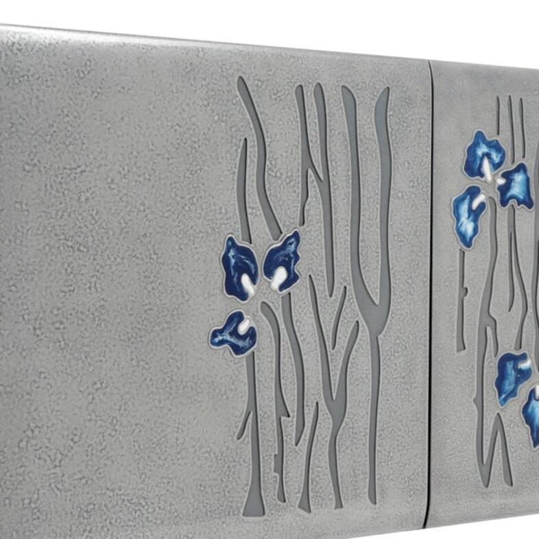 Questa console  riflette un'armonia di eleganza e natura, con una superficie grigia strutturata con motivi floreali blu. Il dettaglio in legno naturale sulla superficie superiore della console aggiunge calore al design, mentre le gambe in metallo
