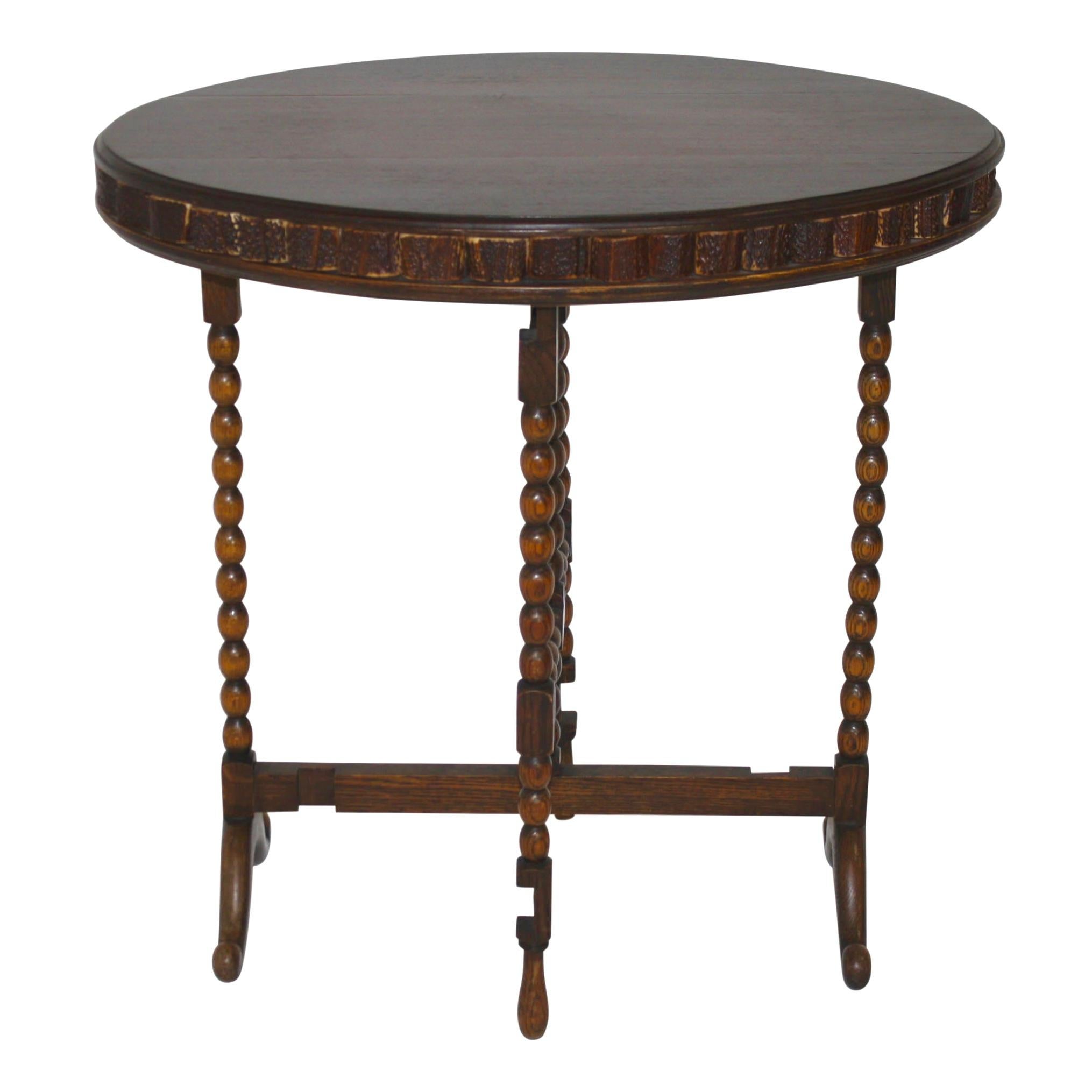 Crafted by designer Brad Ham, this versatile table is comprised of a new, oak tabletop and legs from an antique, gate-leg table. The top is trimmed with segments of stag antlers from Europe. The legs are beaded with rotating, top stretchers, which