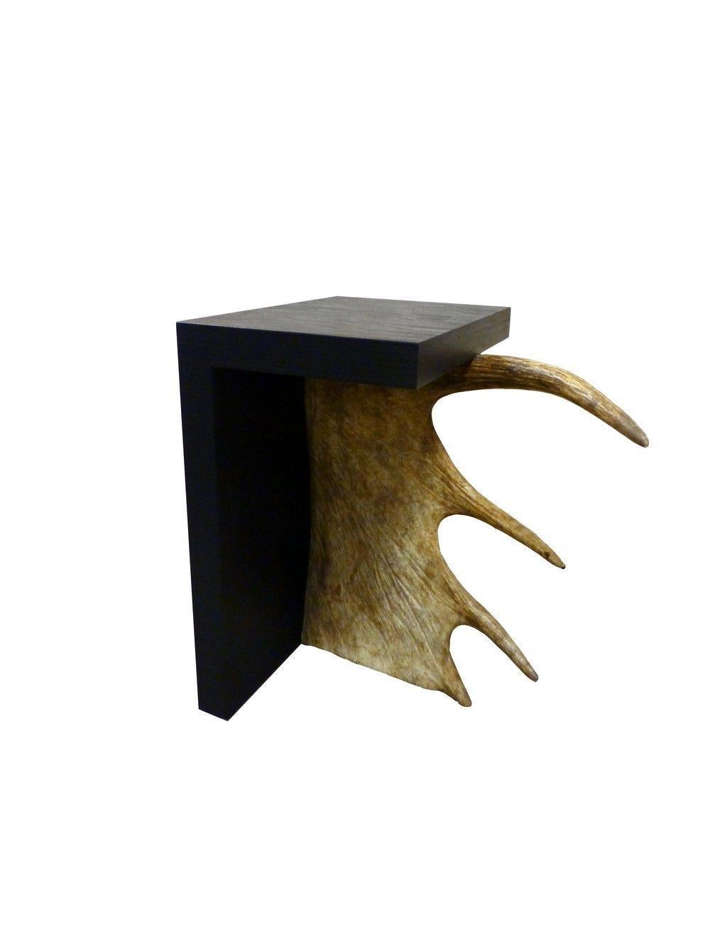 Rick Owens Stag T in black plywood has a T-shape structure and a natural antler moose horn on the side
Stool in Stained Plywood with Moose Antler.

