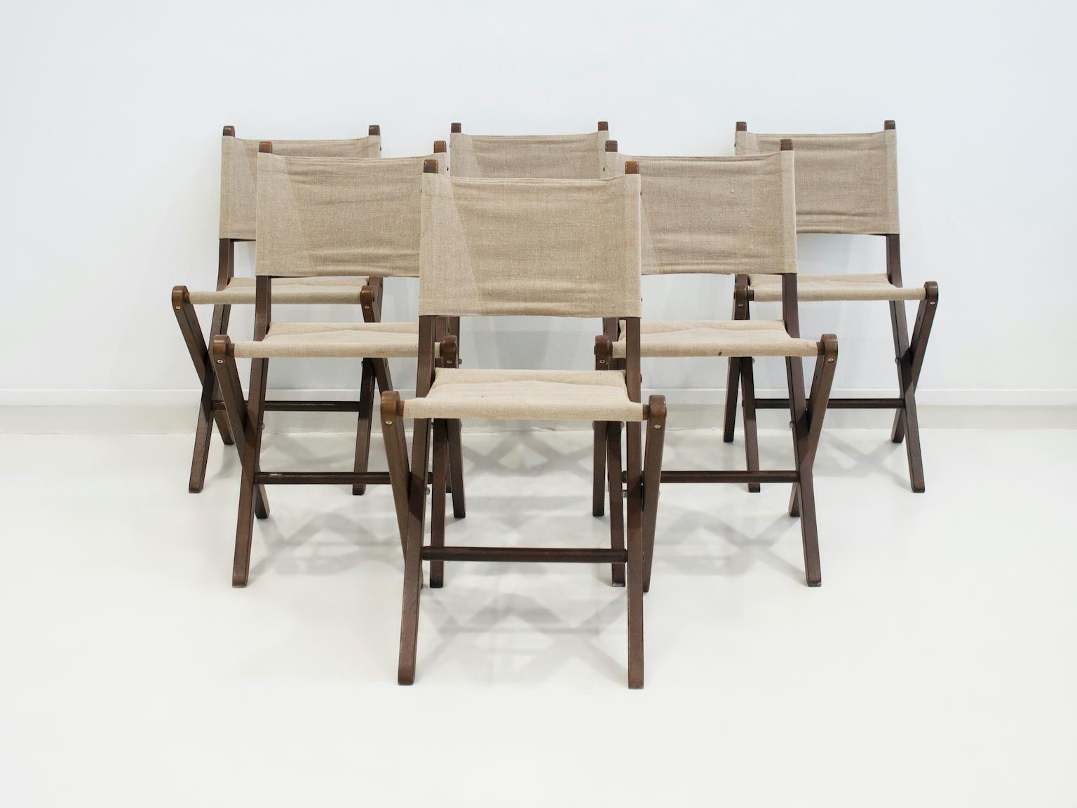 Set of six mid-century folding chairs featuring solid stained beech wood frames and natural canvas seats and backrests. Manufactured in Denmark by Sorø Møbelfabrik, model 330. Their clean, functional design reflects the era's elegant simplicity,