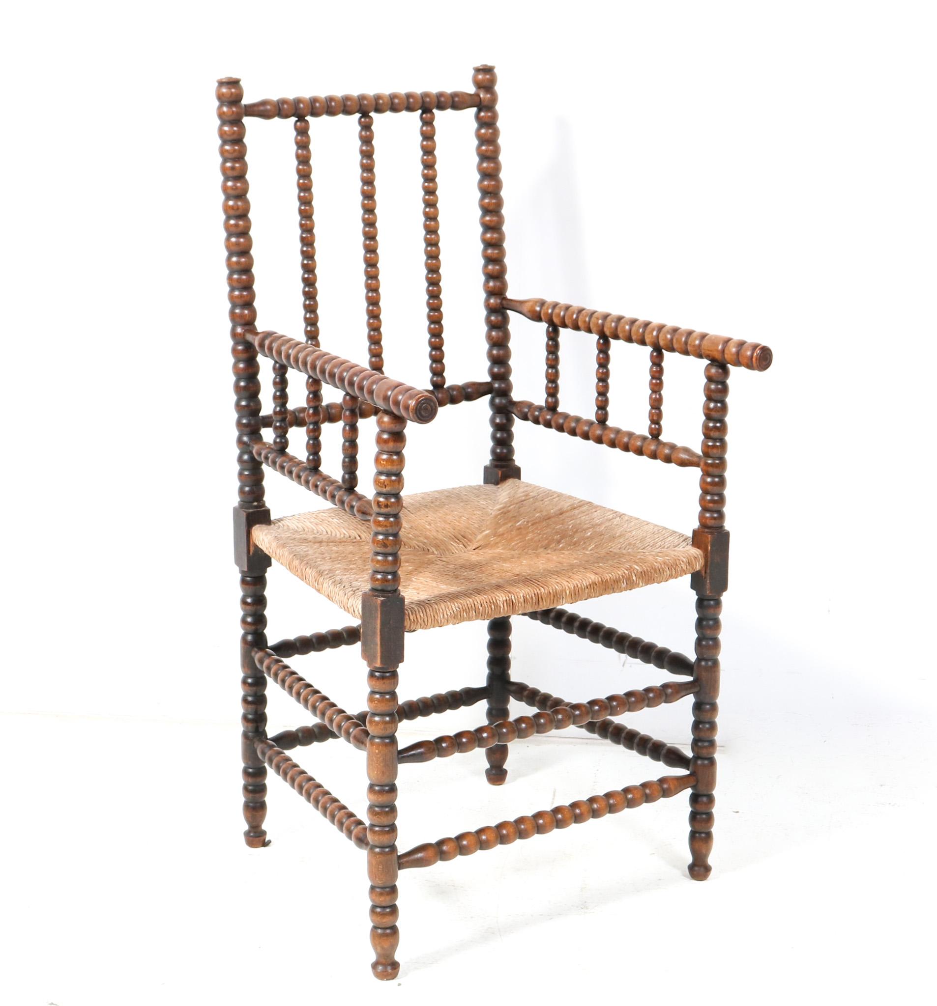 Stunning and rare Jacobean style bobbin armchair.
Striking Dutch design from the 1900s.
Solid hand-crafted stained beech frame with bobbin turned back, legs and supports.
Original woven rush seat.
This wonderful Jacobean style bobbin armchair is in