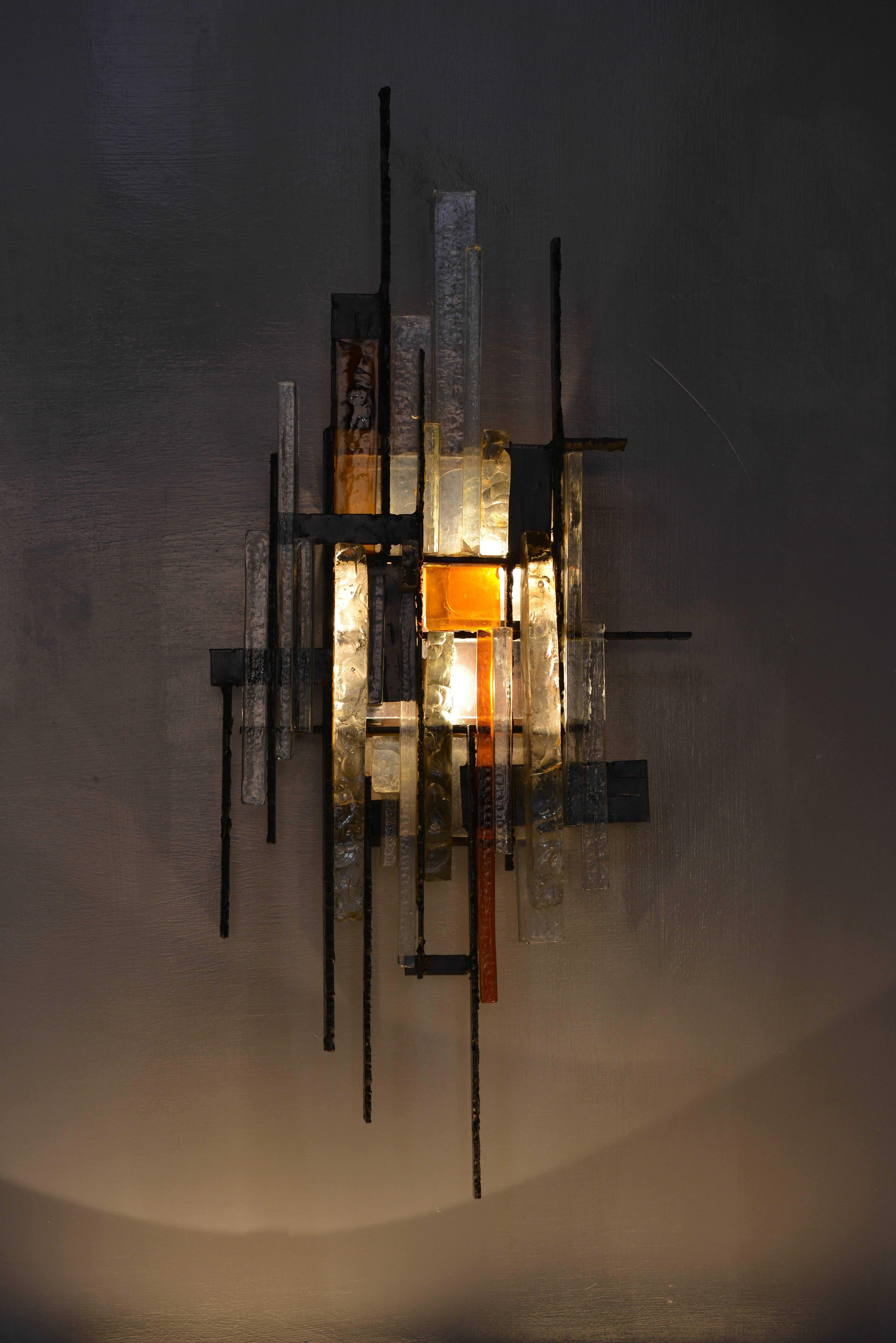 Designed by Albano Poli for Poliarte. The sconce has three internal lightbulb fixtures.