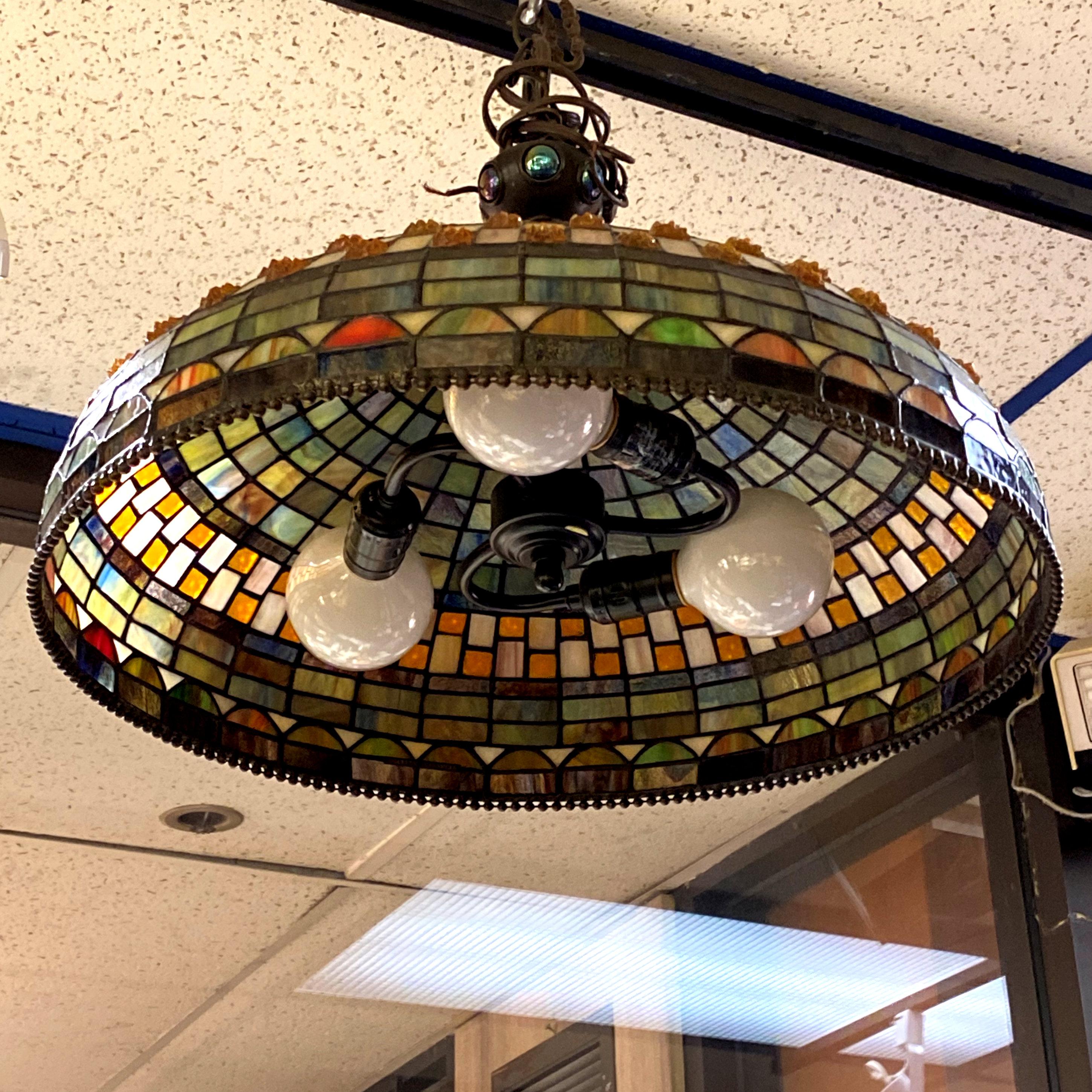 Stained glass ceiling lamp in the Arts and Crafts Style. Approximately 24 inches in diameter and 12 inches tall.