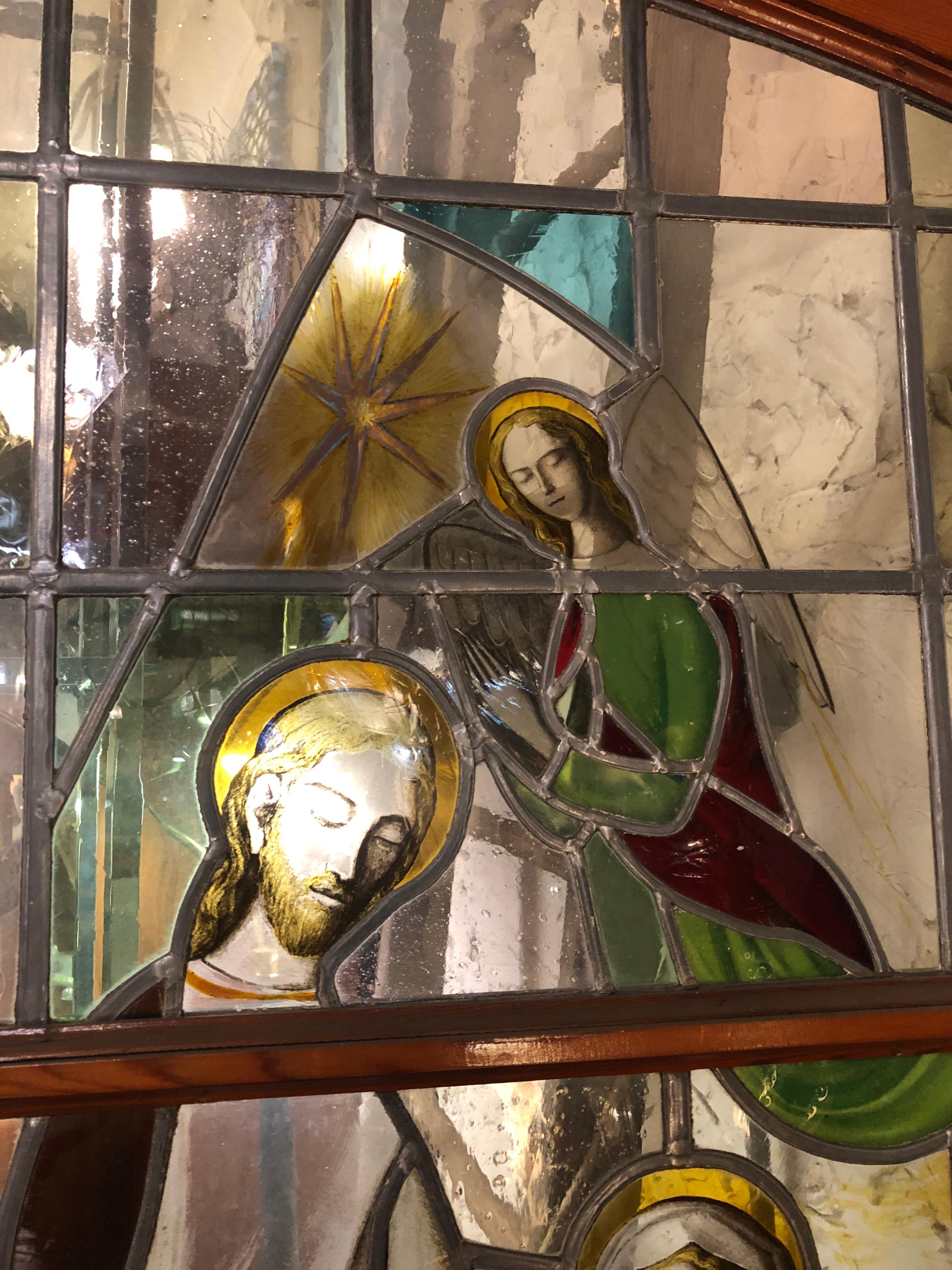 This pair of magnificent doors come from inside a church, and feature two religious scenes with Latin text. Beautiful coloring and leaded designs depict Mary, Joseph and child, with angels.
Bottom inscription reads: 
Gloria In Excelsis Deo - Latin