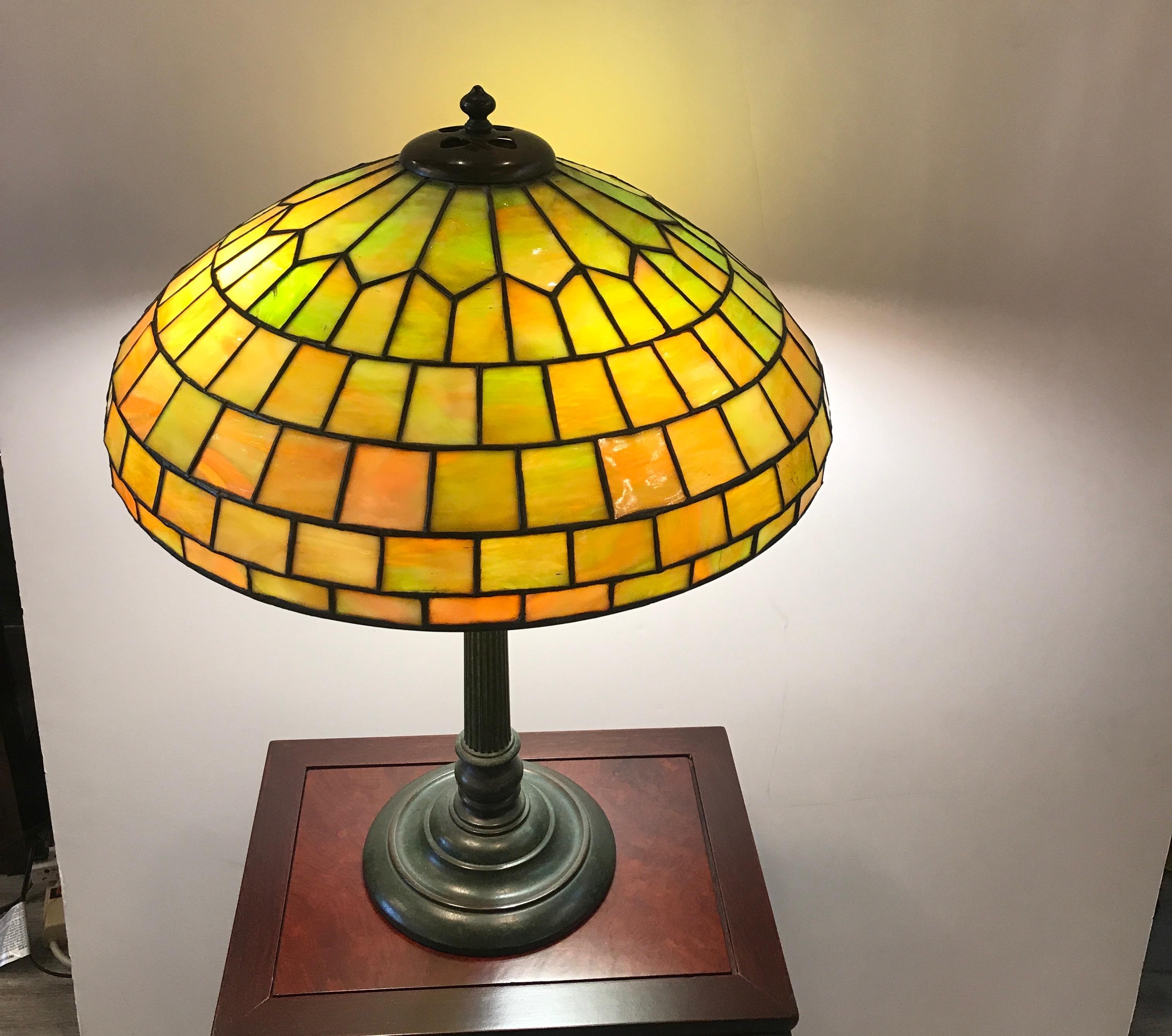 A leaded glass and bronze table or desk lamp, early 20th century
Duffner & Kimberly was a New York City company which produced leaded glass and bronze lamps around the same time as Louis Comfort Tiffany, Tiffany Studios. The Duffner & Kimberly