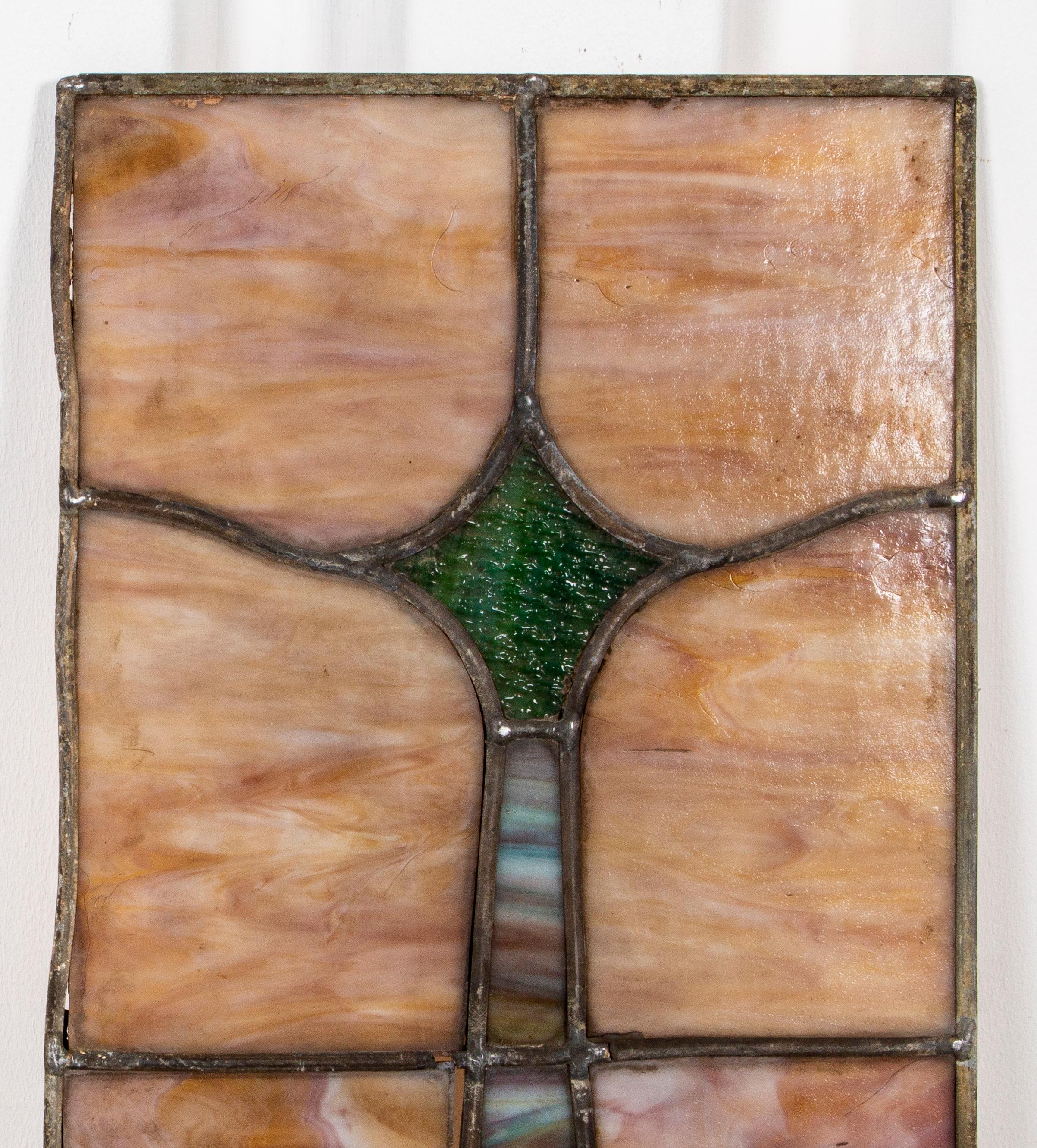 Three stained glass panels, circa 1900. 45.25” H x 10” W. Losses.