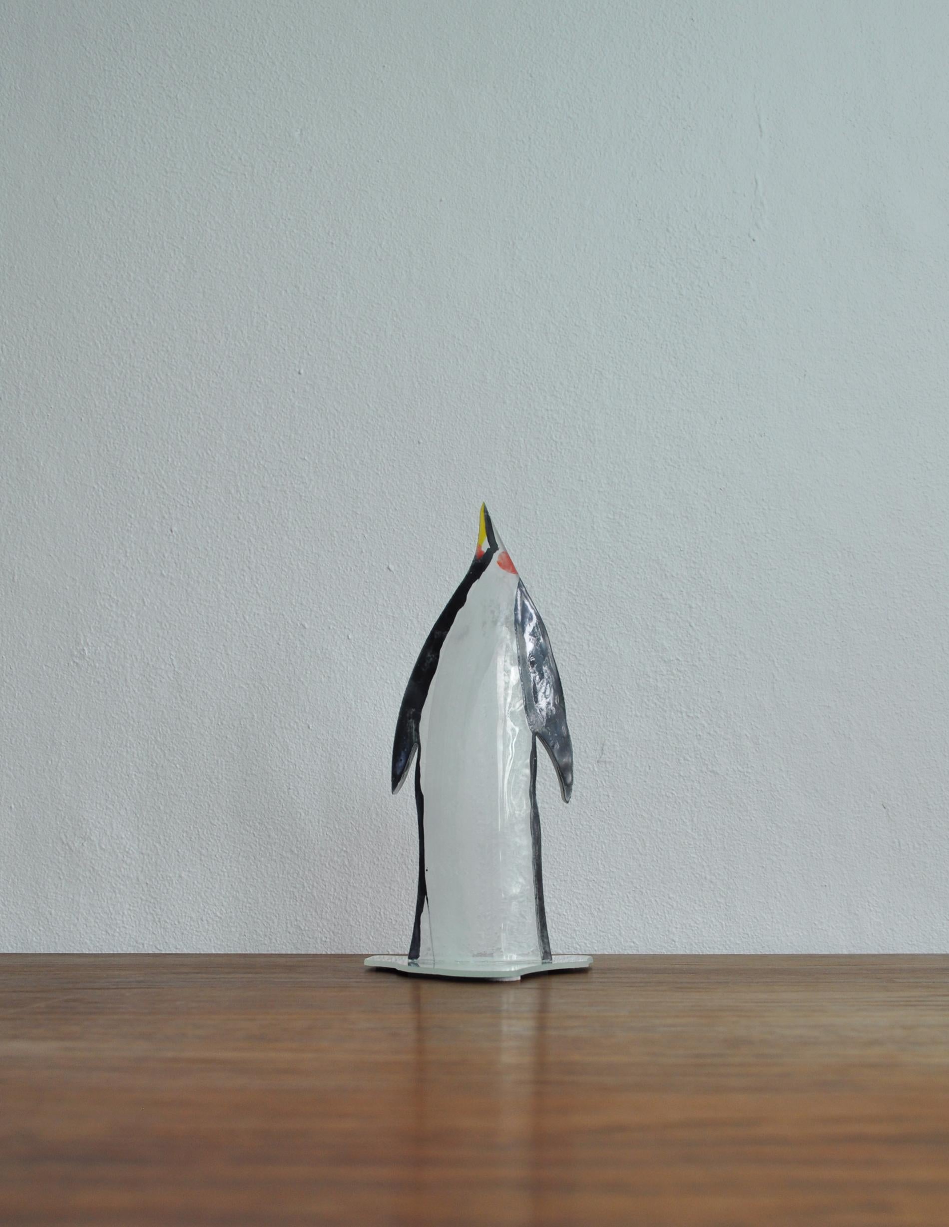 Stained glass pinguin sculpture mounted on mirror base
by the Danish artist Peter Stuhr.
Measures: H 16 cm x W 7.5 cm x D 6 cm

Peter Stuhr's paintings consist of an expressive picture universe made up of streams of sieving color and transparent
