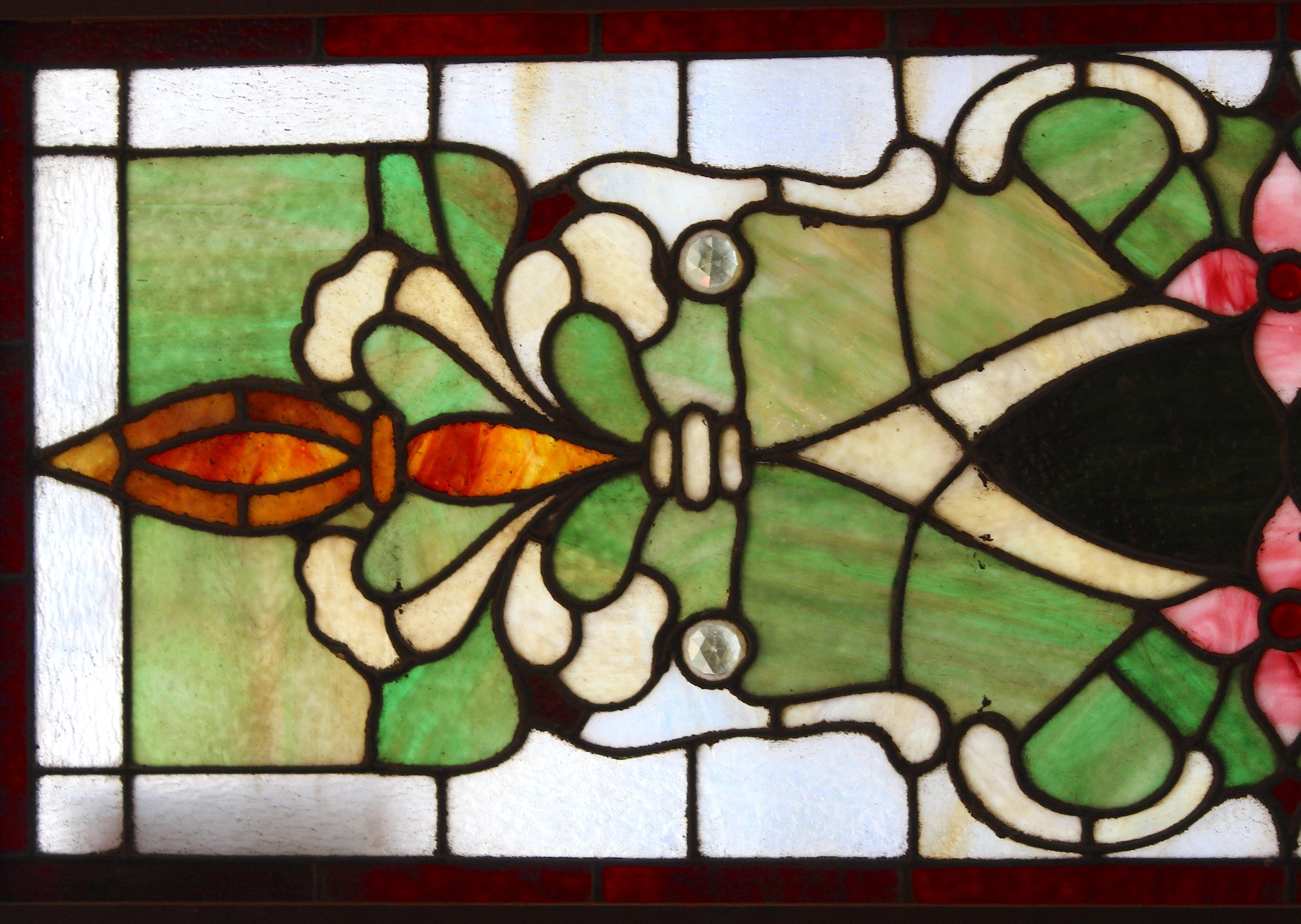 Long five foot transom window with wonderful colored glass. Floral designs and marbled green glass.
Currently housed in a wooden frame - the overall dimensions are for the stained glass and the frame.
Located in NY