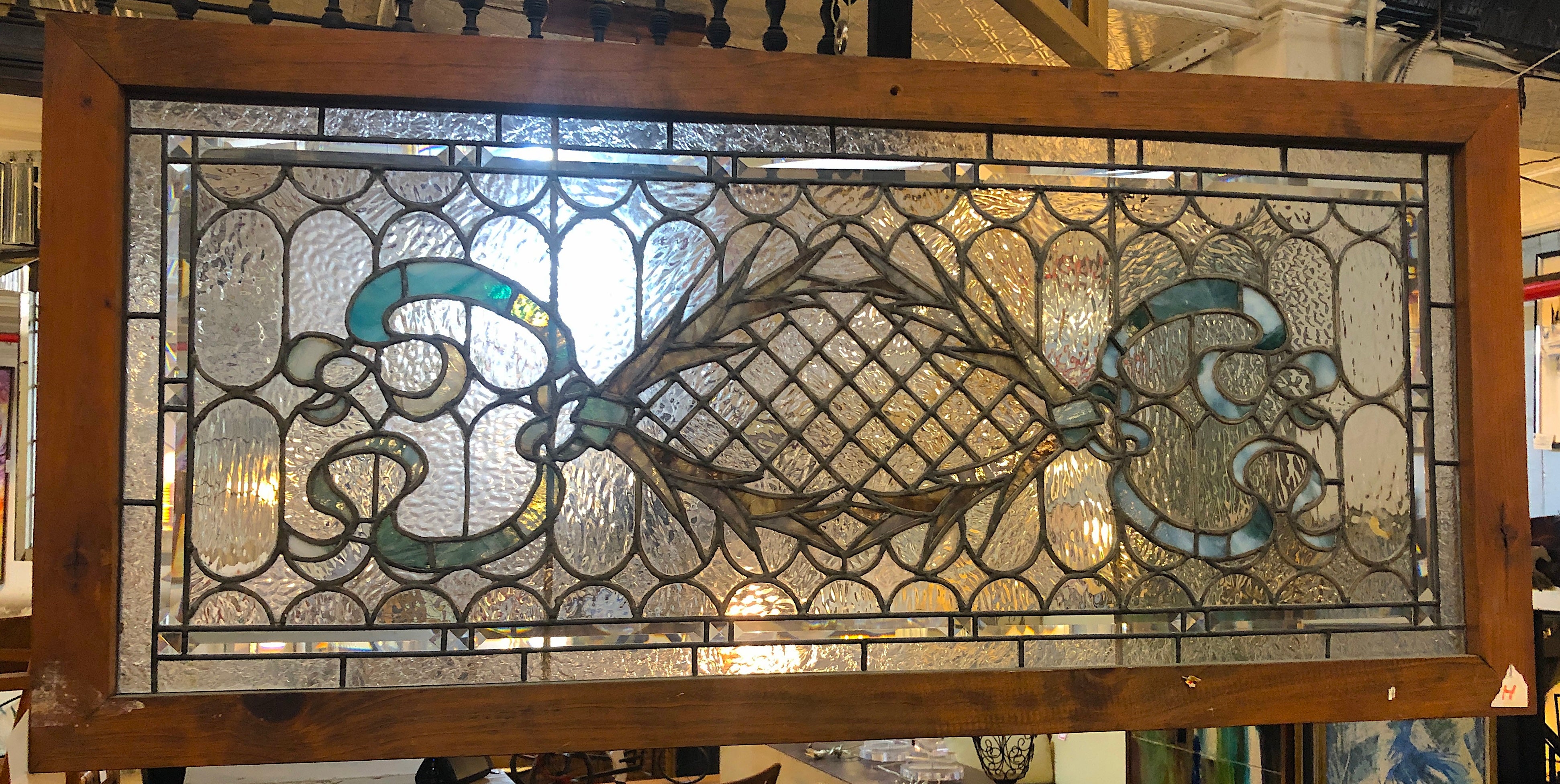 Langes Buntglasfenster aus der Jahrhundertwende. Dekoratives Kranz- und Schleifenmuster.
Derzeit in einem provisorischen Holzrahmen untergebracht - die Gesamtmaße gelten für die Glasmalerei und den Rahmen.
Sitz in NY