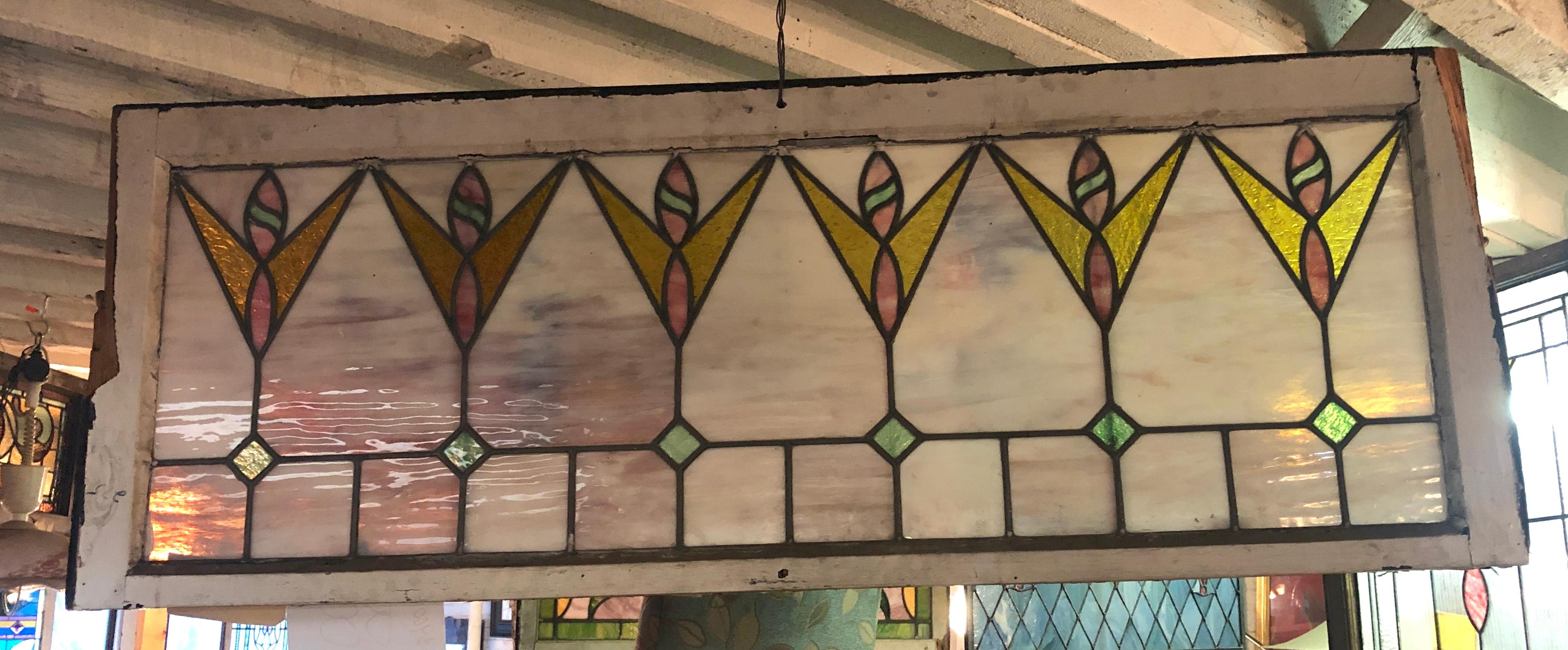 Stained glass transom window from the turn of the century. Beautiful leaded design with colored glass.
Currently housed in a temporary wooden frame - the overall dimensions are for the stained glass and the frame.
Located in NY