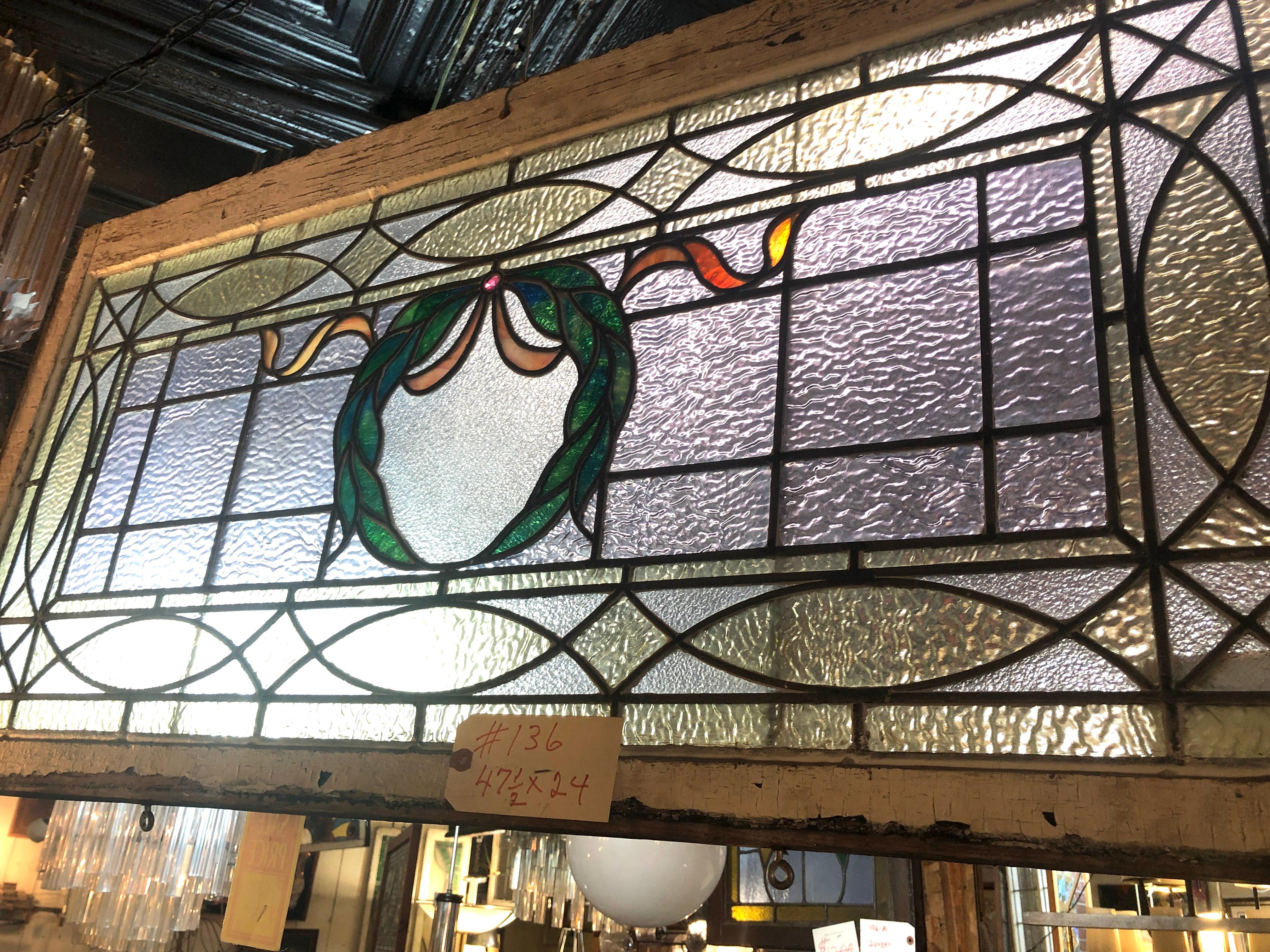 American made stained glass window with wreath design. Wonderful coloring and led work.
Currently housed in a temporary wooden frame - the overall dimensions are for the stained glass and the frame.
Located in NY