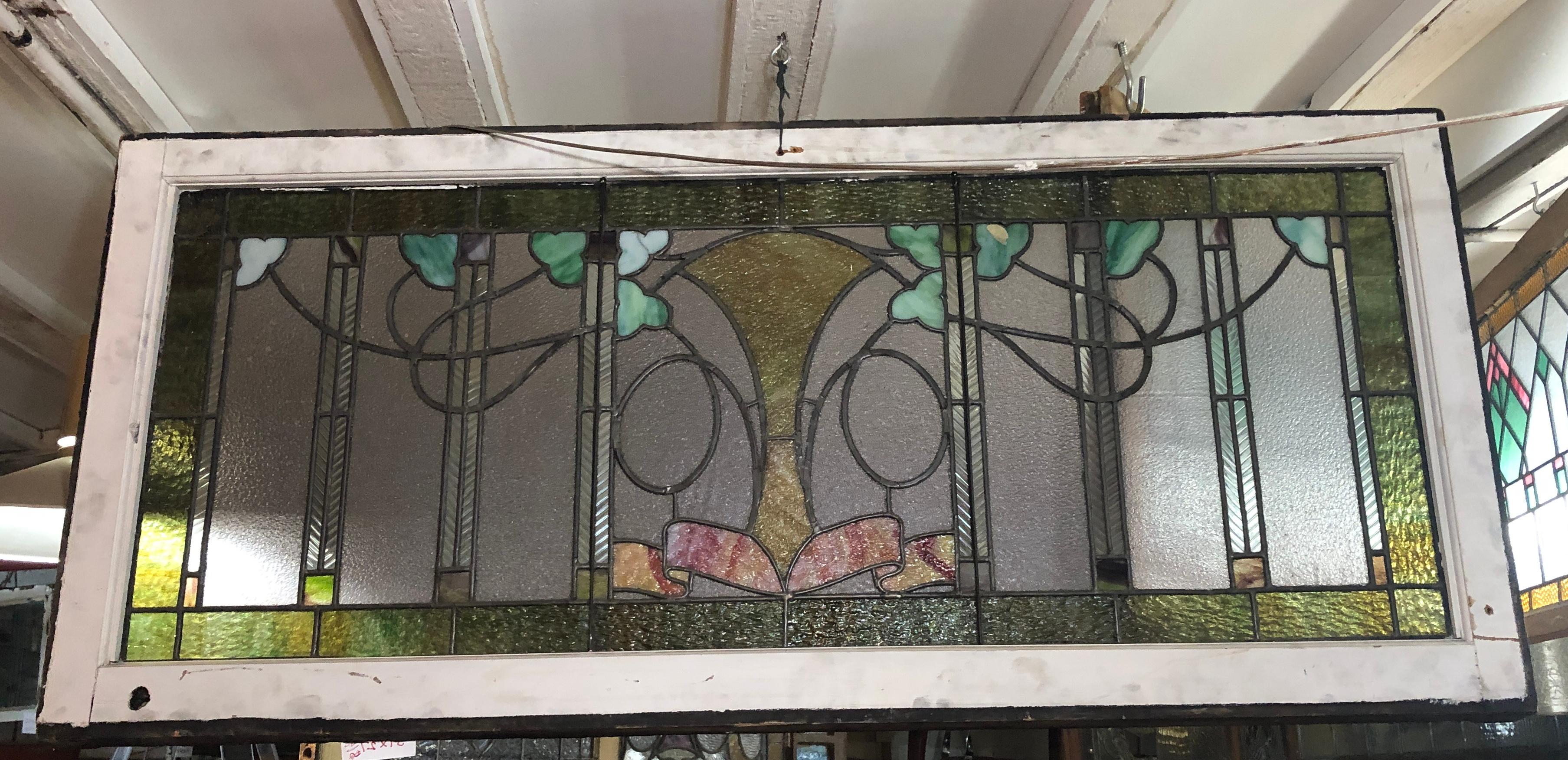 Early American window made of stained glass and leaded outlines showing ivy and ribbons.
Currently housed in a temporary wooden frame - the overall dimensions are for the stained glass and the frame.
Located in NY