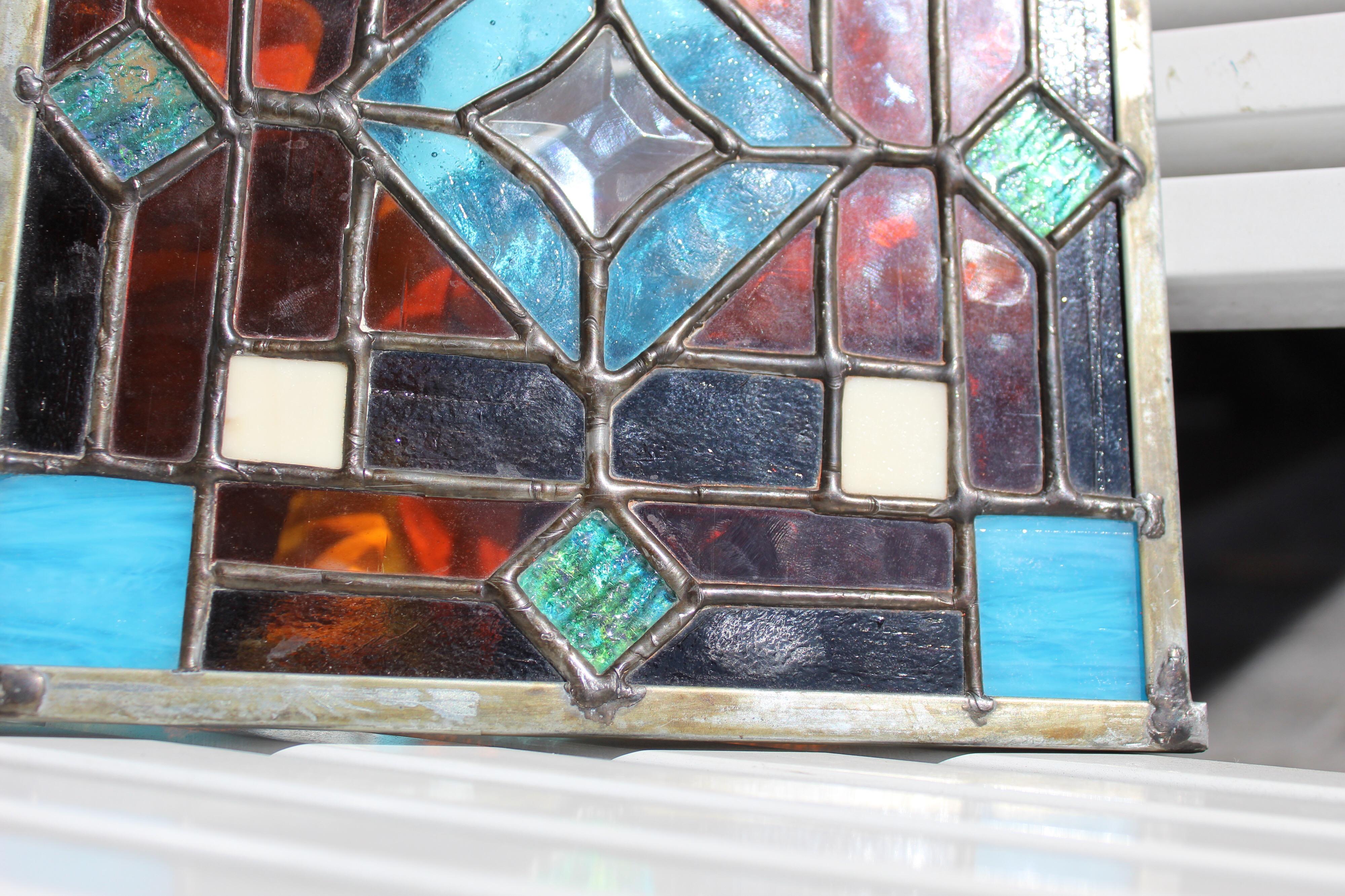 Great piece is made of the highest quality colored glass in the stained glass technique. The piece used to be in a old door, we believe is maybe from the 1920s.
 