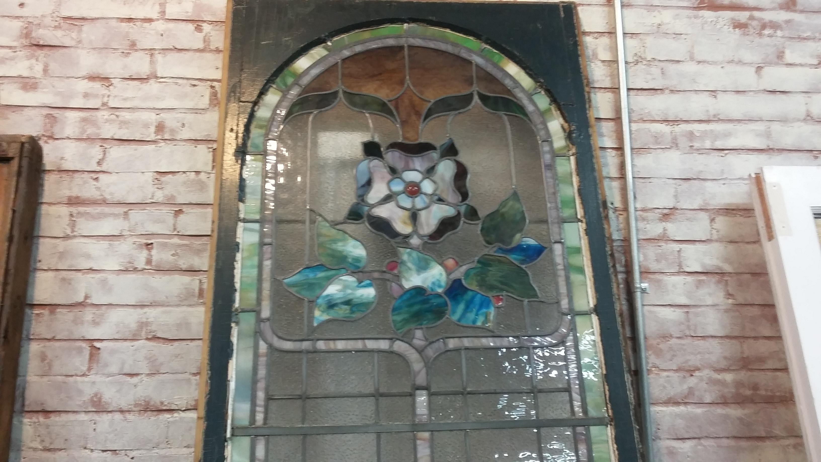 Beautiful Victorian (1890) stained-glass window. In original frame with arch to the very top. Five very small cracks at the bottom of the window but glass is secure. Wonderful vibrant colors throughout the window. The bottom of the window is 