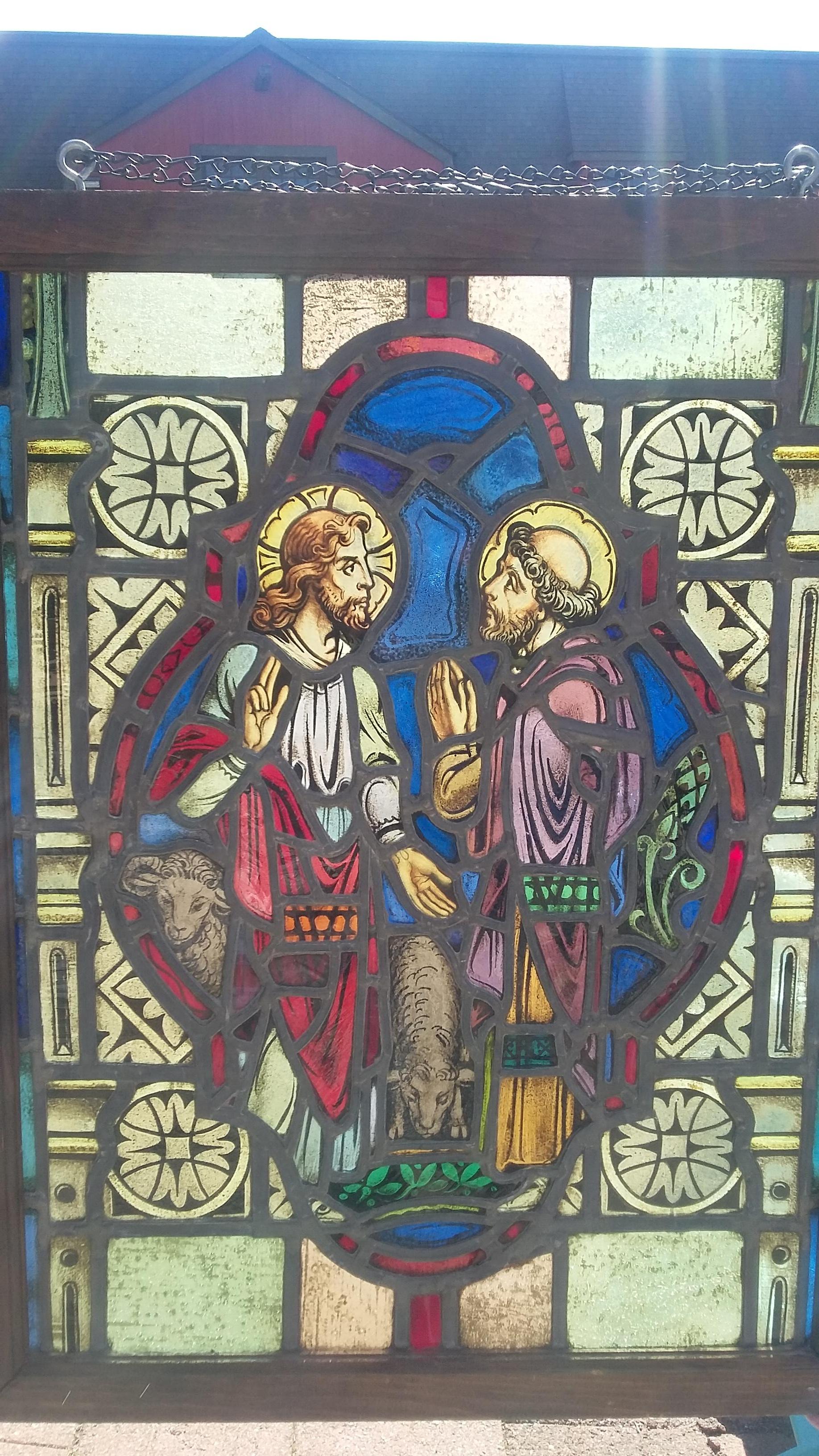 Beautiful vintage 19th century stained-glass window. Excellent condition depicting Jesus and an unknown saint (St. Peter ?). The faces are hand painted and very detailed. There are also two painted lambs on the bottom left. Nice small sized window