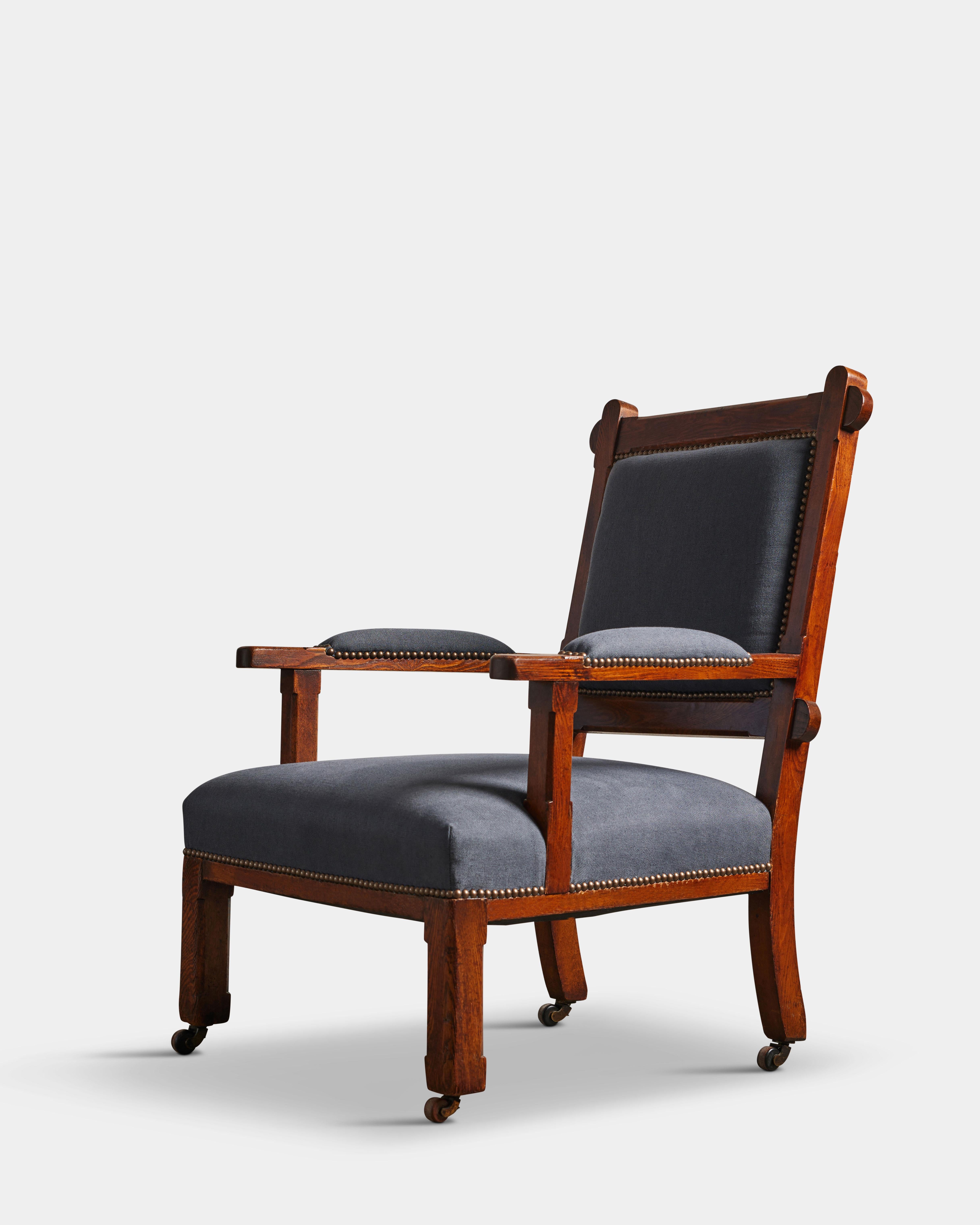 Stately stained oak and linen armchair with quintessential arts % crafts detailing. Newly reupholstered and thoughtfully restored