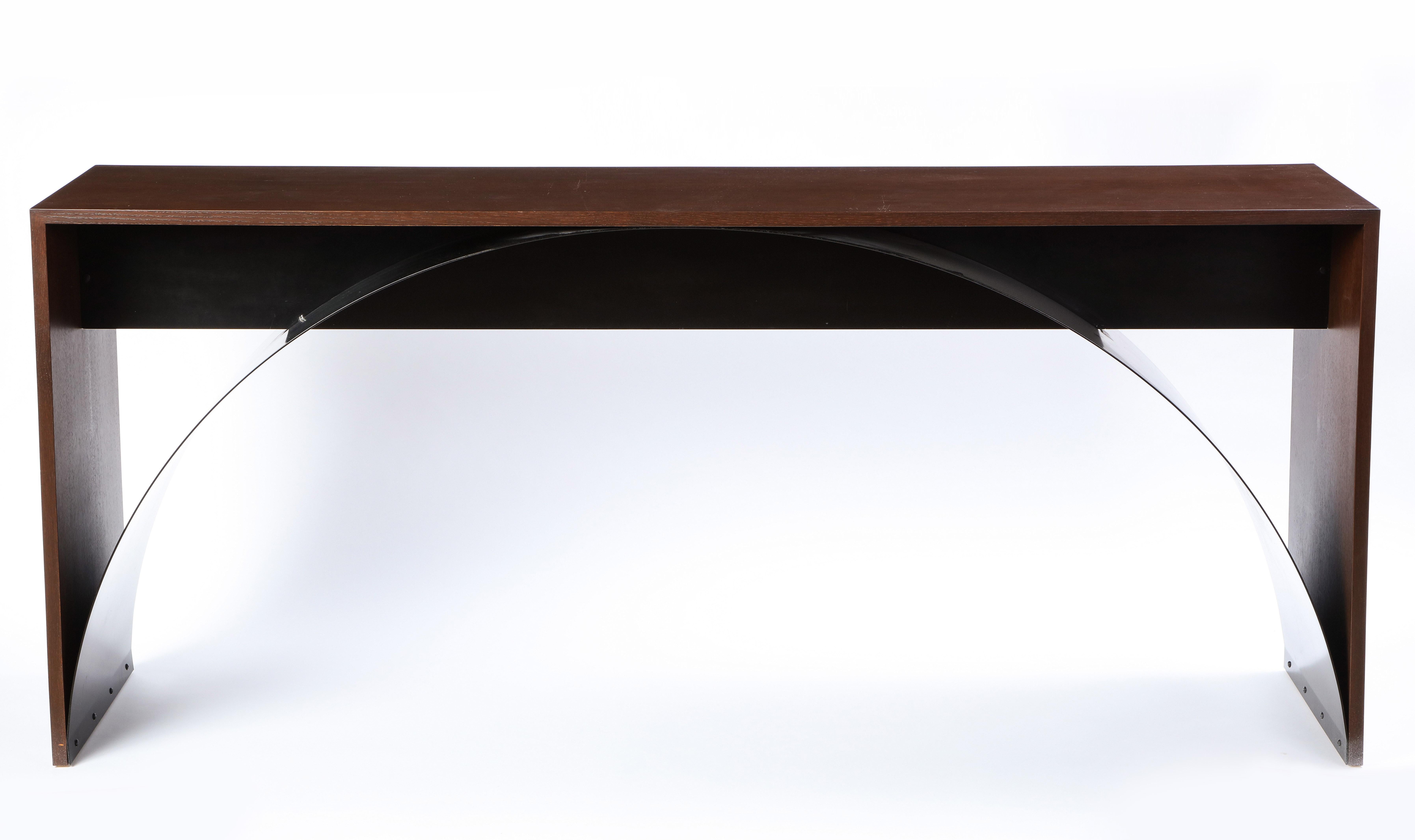 This modern console table is composed of a stained oak frame with a black painted metal sheet spanning in an arch from foot to foot. The formal simplicity and the crispness of the lines highlights the subtle and nuanced workmanship of the piece -