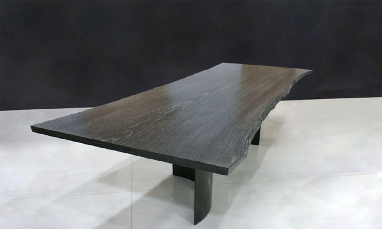 Ebonized stained oak with silver rub and curved, blackened steel legs.