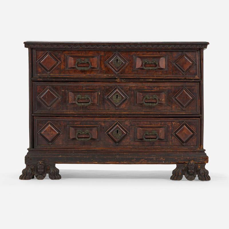 Cabinet features a fall-front writing surface opening to a fitted interior concealing twelve drawers.The rectangular moulded top above a frieze carved with Vitruvian scrolls on figural carved feet