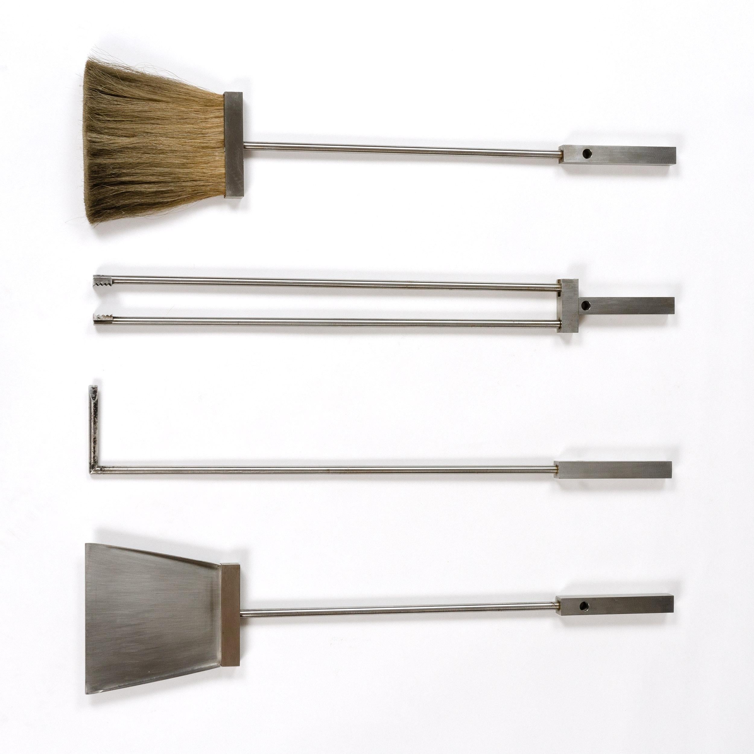 A set of four (4) machined brushed steel fire tools with squared handles. Mid-Century Modern styling.