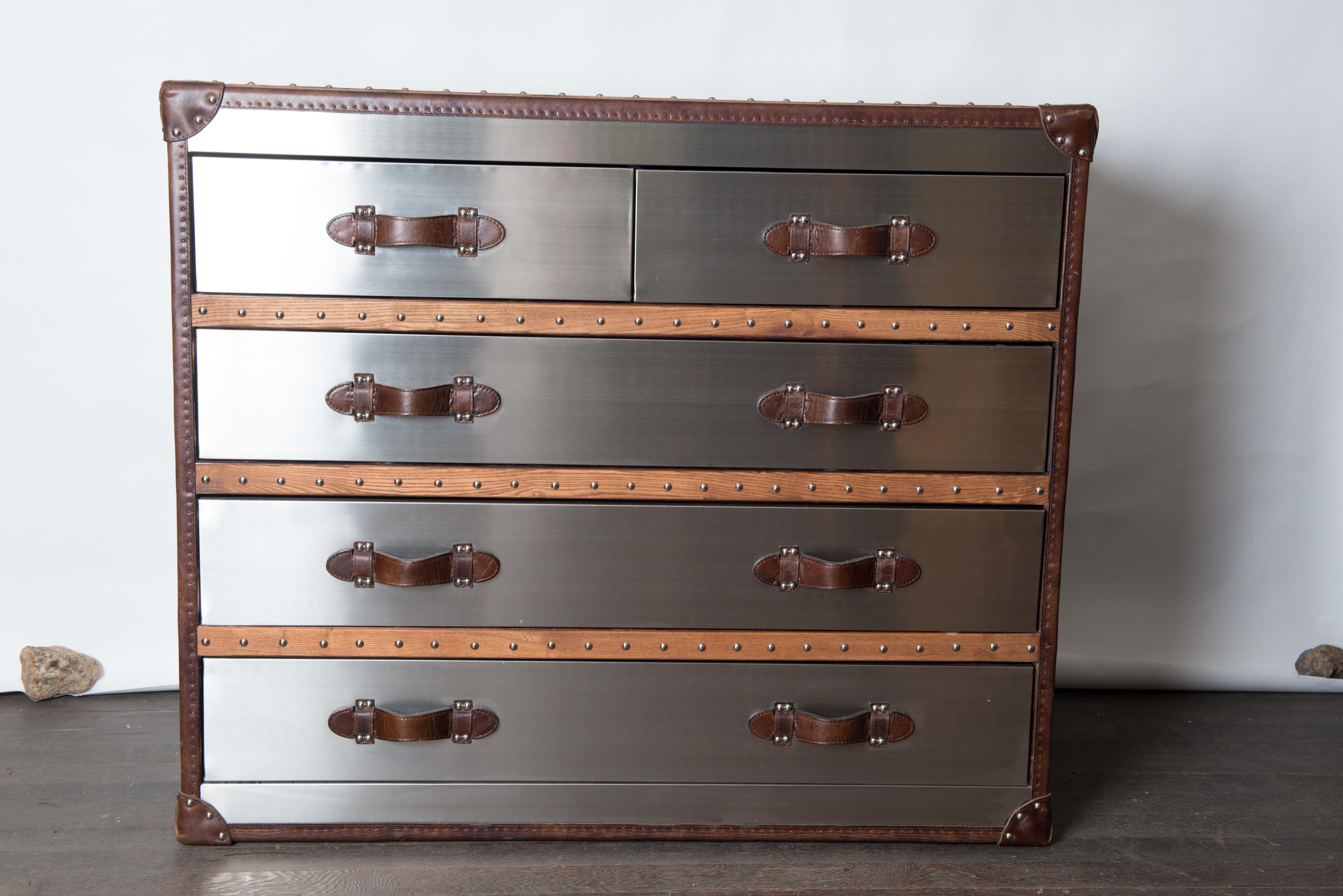 Italian custom made stainless steel, leather, wood, nailhead steamer trunk style chest of drawers. Extremely well crafted. Black interior drawers. The piece is weighted and quite substantial.