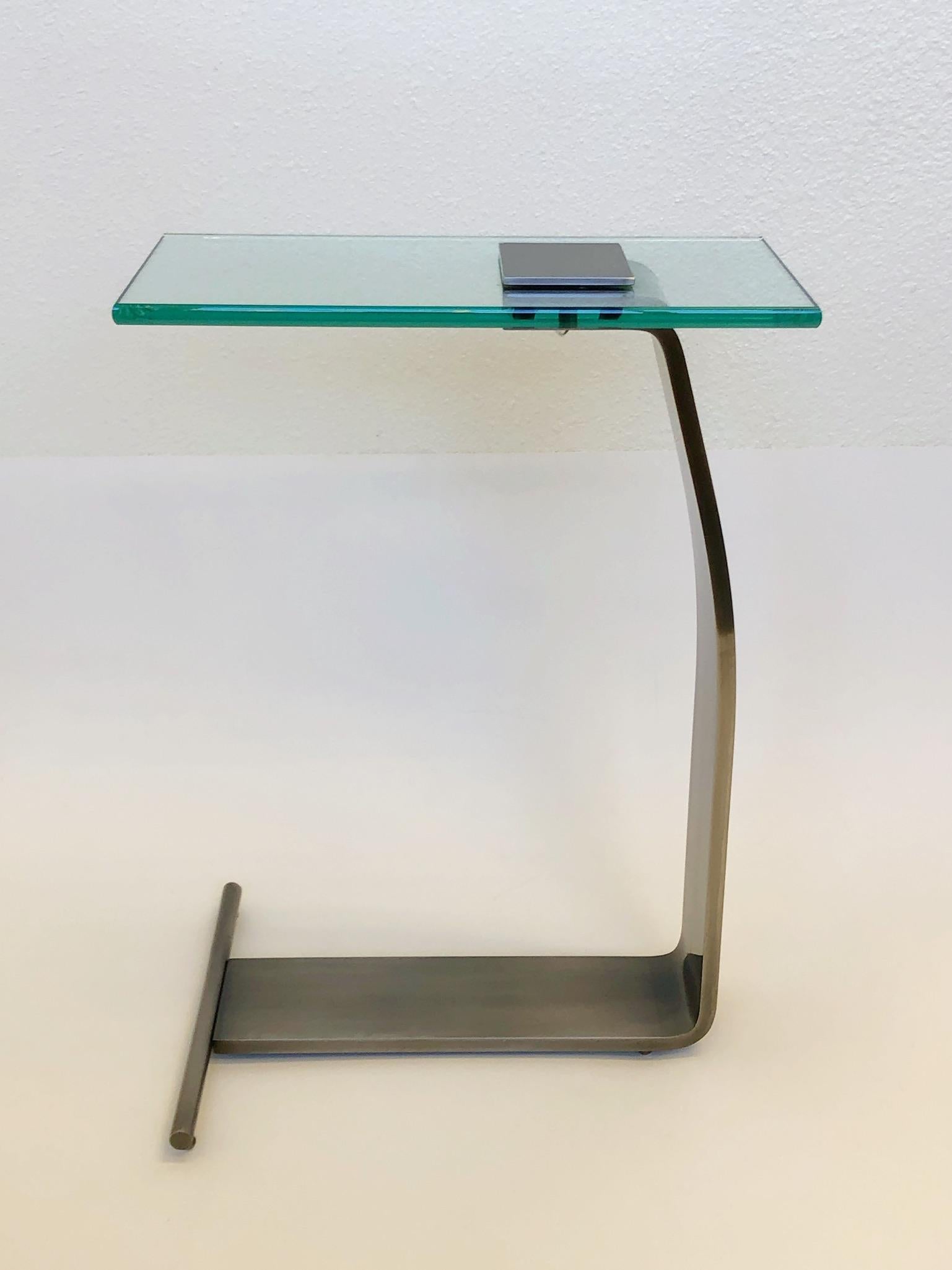 A stainless steal and glass top occasional table design by Kaizo Oto for Design Institute of America in the 1980s
Dimensions: 22” high, 16”wide, 8” deep.