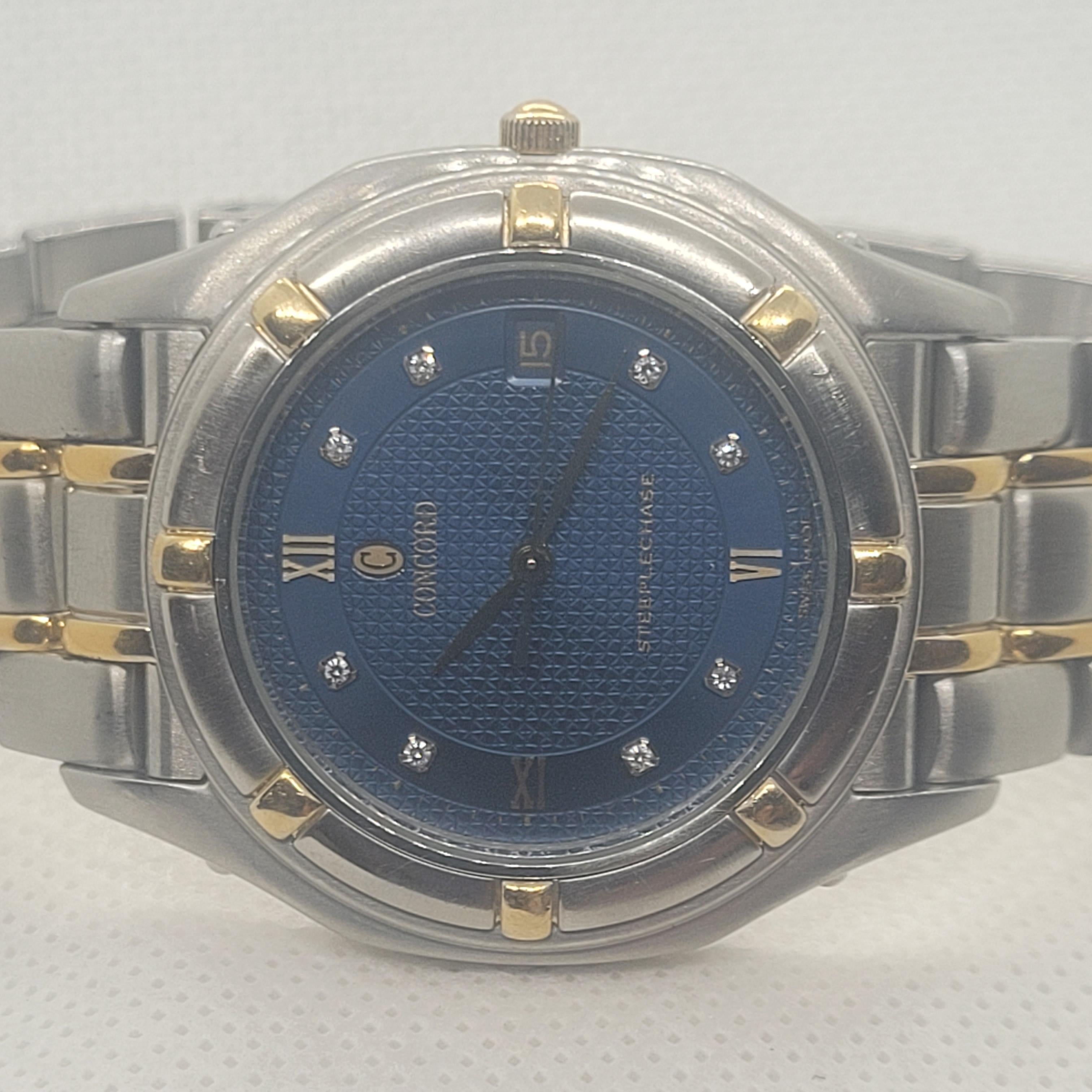 Introducing the stunning Men’s Concord Steeplechase watch, a remarkable fusion of stainless steel and luxurious 18kt yellow gold. With a 35mm case that boasts a sleek thickness of 6.87mm, this timepiece catches the eye with its navy blue textured