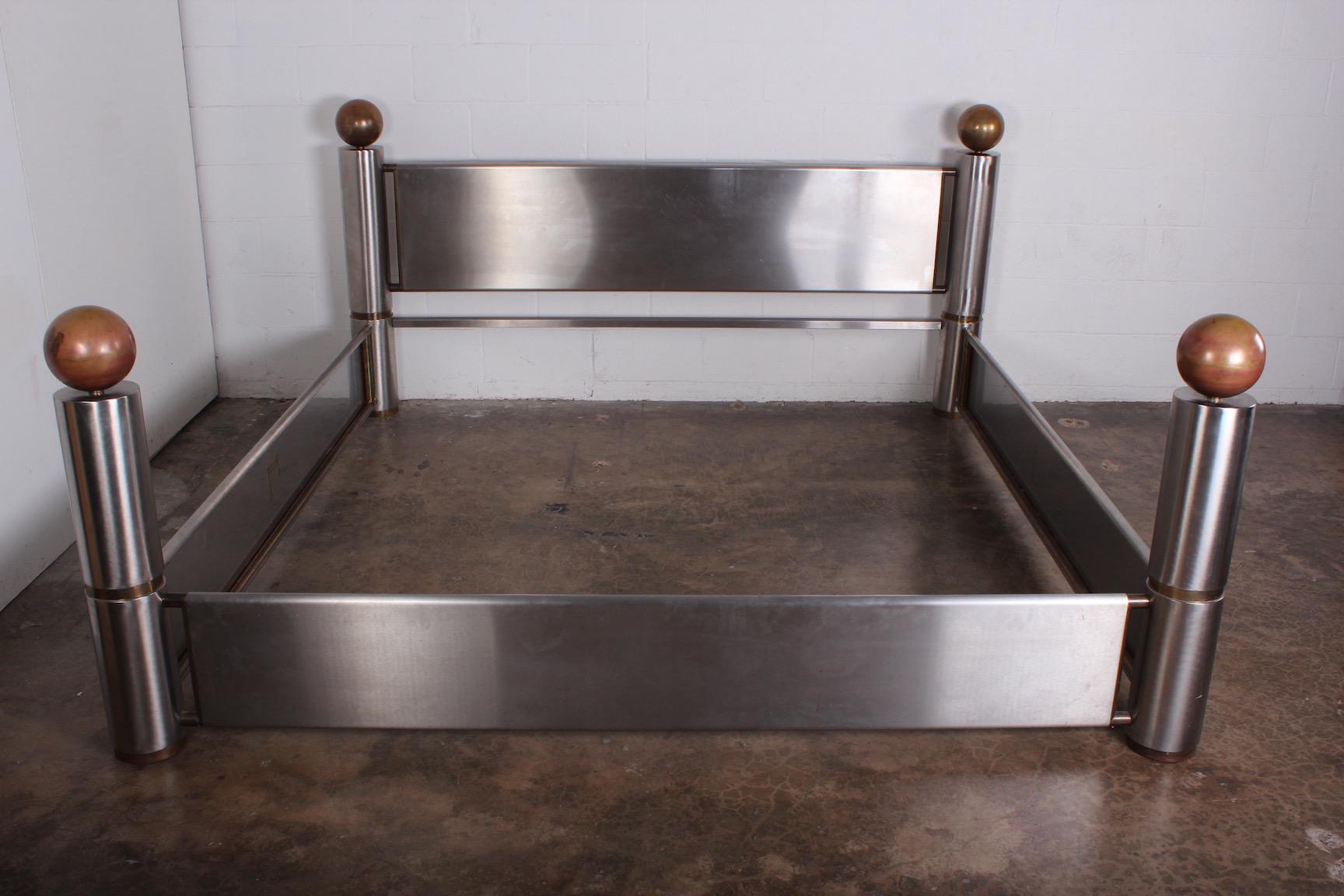 A finally crafted stainless steel and patinated brass king size bed, 1980s.
Interior measurements: 81.5 x 83.75.