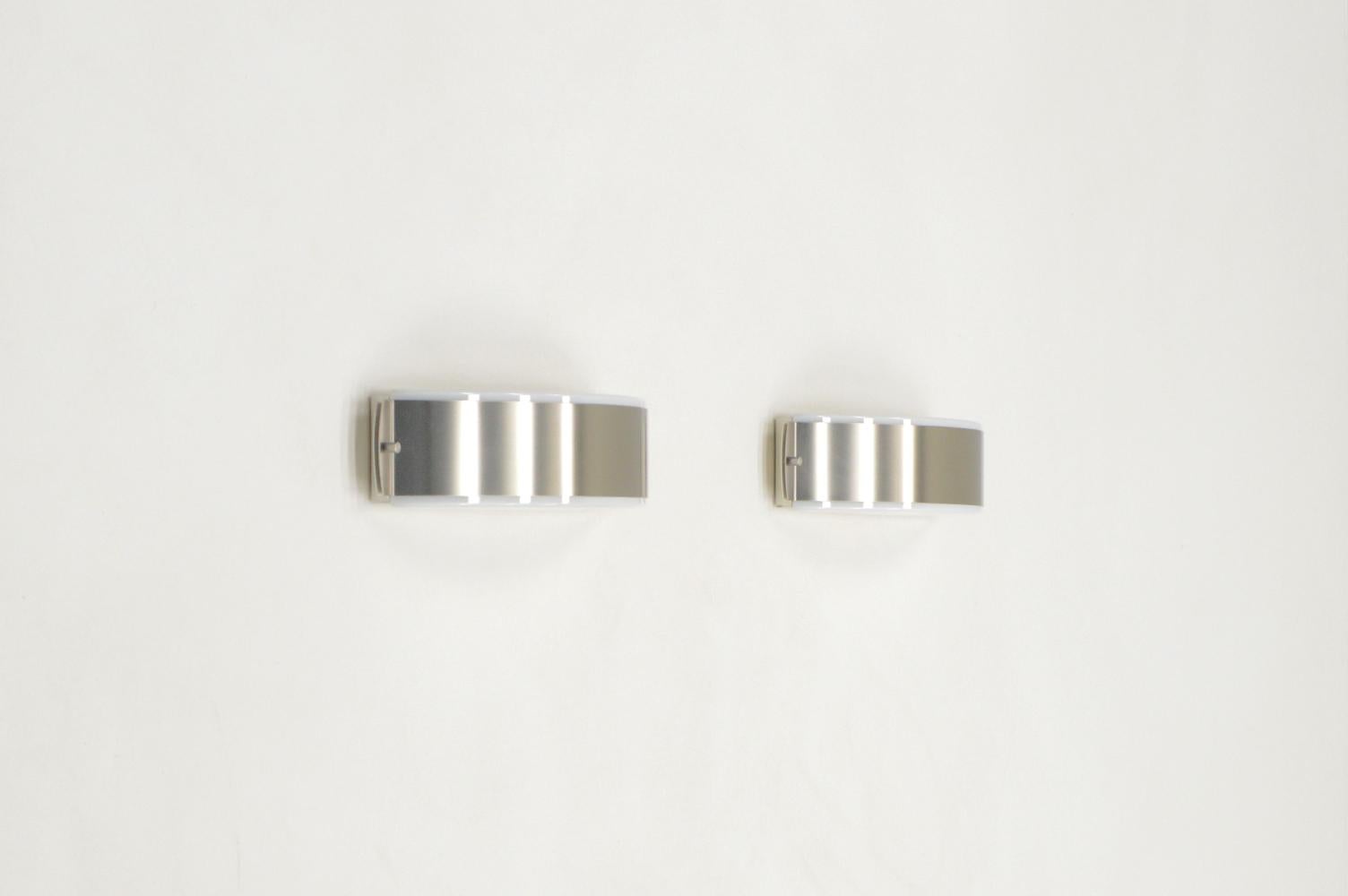 Stainless steel and glass wall lamps made by Glashütte Limburg, 1970s Germany. Up and down light. White opaline glass and brushed stainless steel shade. Big lamps with a width of 40cm. You can hang them vertical or horizontal. Holds 2 E27 fittings.