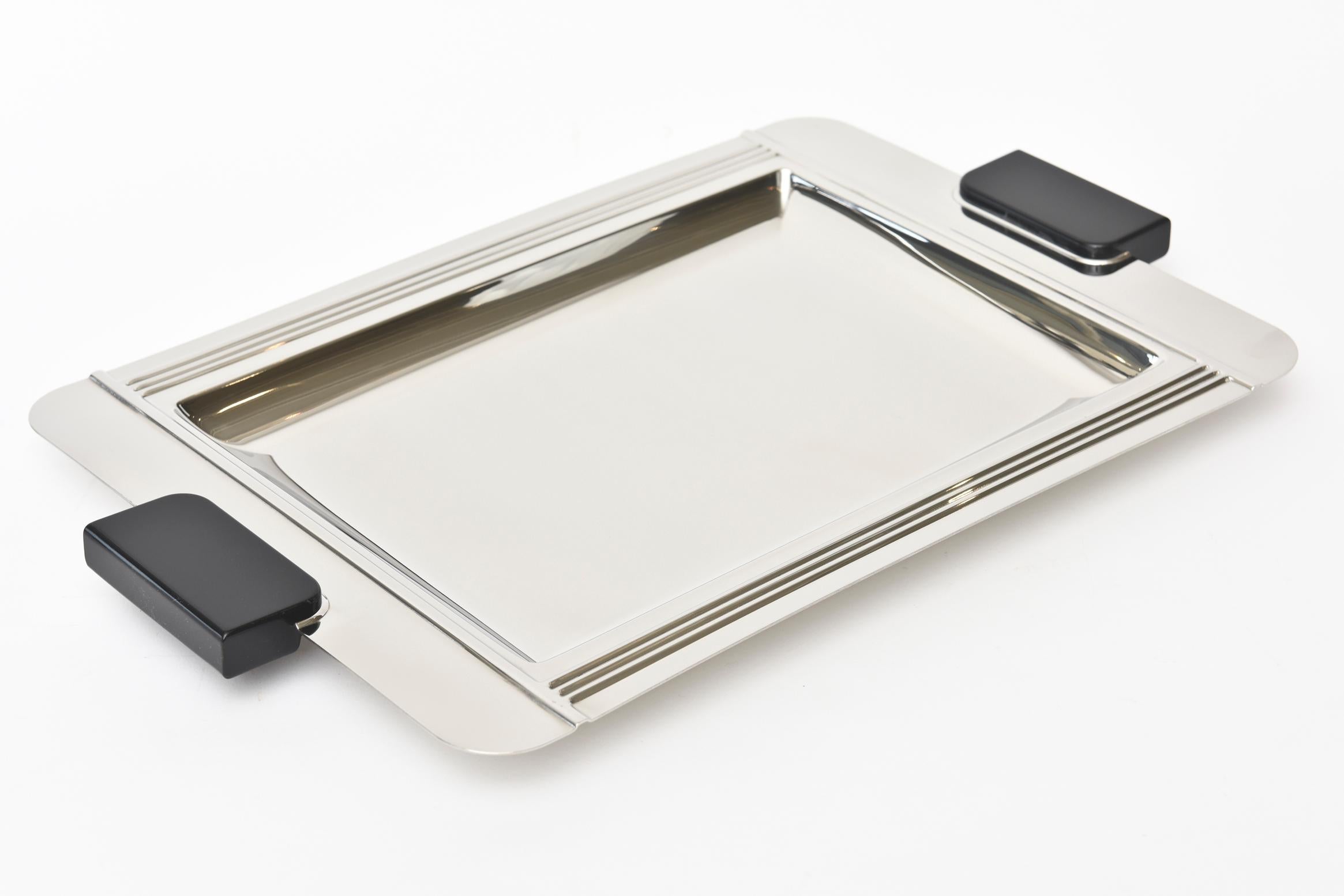 This wonderful French polished Art Deco stainless steel and resin handled tray is signed Couzon Acier Inox 18/10 France. The deco lines add to the simplicity and handsome lines to the tray. Great barware and a great serving tray.
The inside