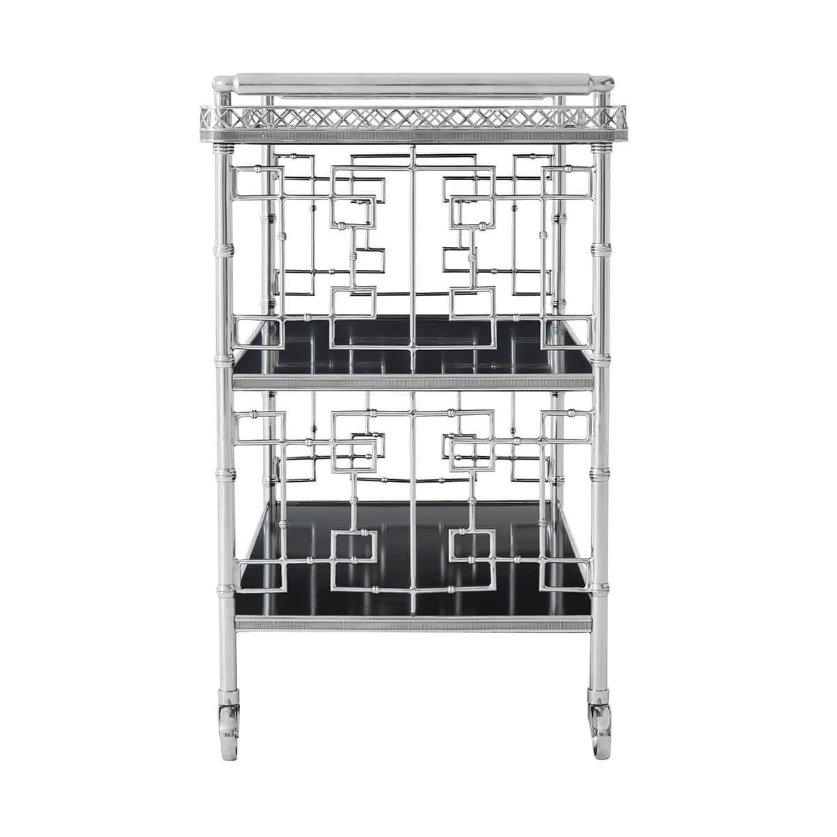 A stainless steel drinks cart, with a rectangular hand silvered mirrored top surrounded by a partial pierced gallery and handles to the side, with open interlacing geometric sides and an open front and back, with two black lacquered bound tiers