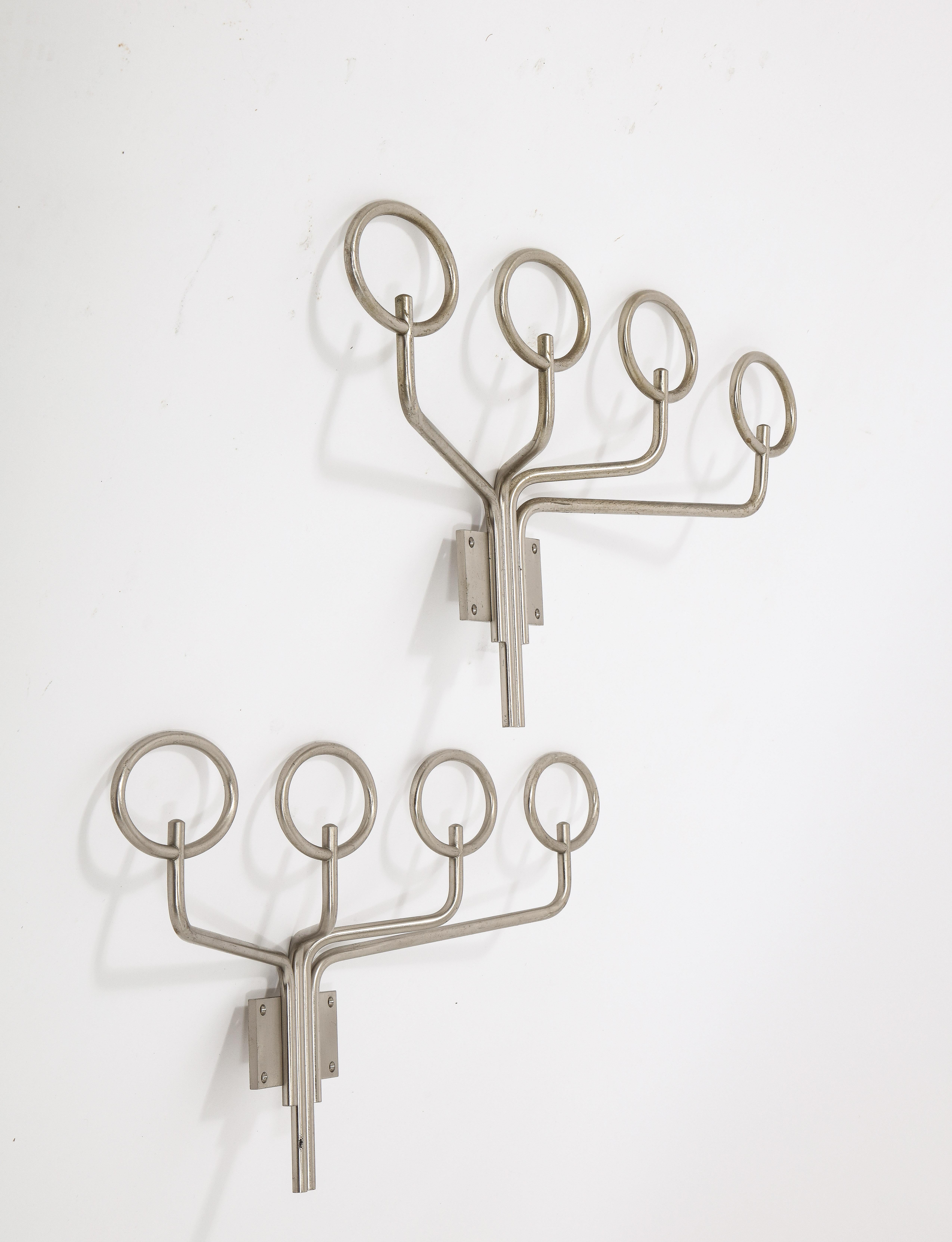 A pair of sculptural stainless steel coatracks with a distinctive 70's flair.