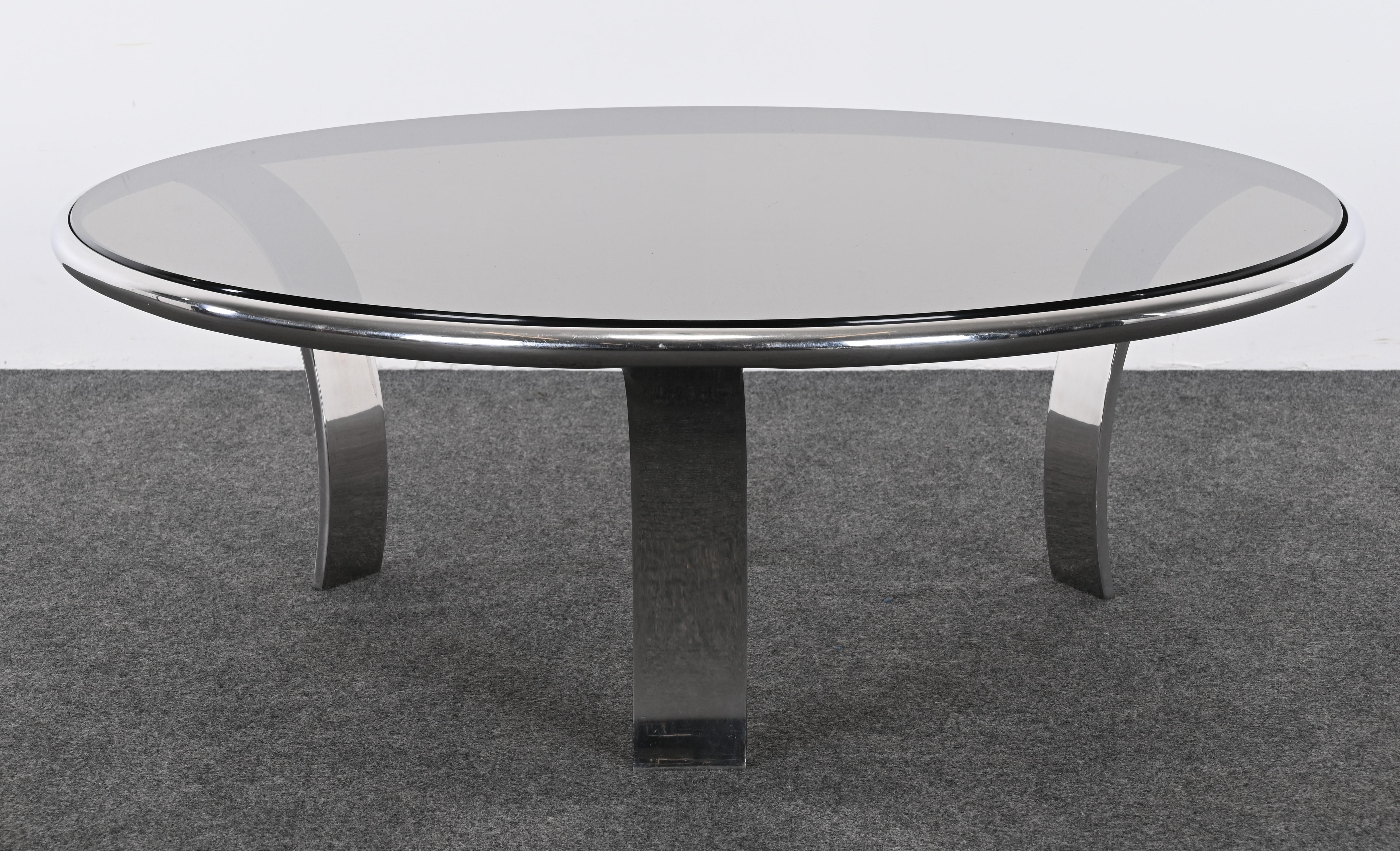 A Mid-Century Modern stainless steel coffee table with a smoked glass top. This table would look great in any Contemporary or Modern home or apartment. Great Size and a great statement piece! The table is structurally sound and in good condition