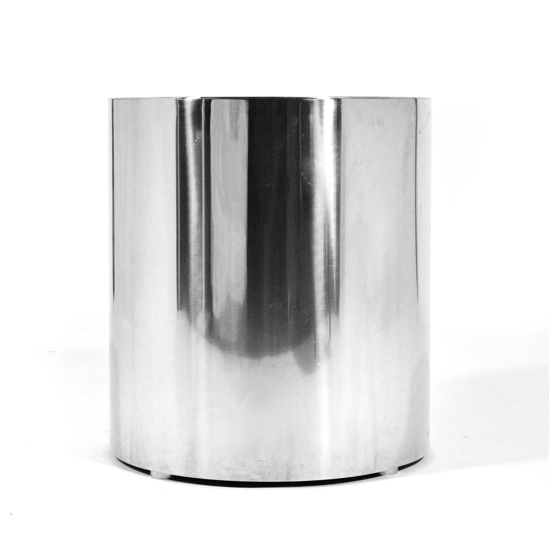 An impeccably crafted side table of stainless steel, this custom made drum table is a great minimalist form that can work as a side table, end table, nightstand, center table, or pedestal. It has four adjustable feet that keep it suspended slightly