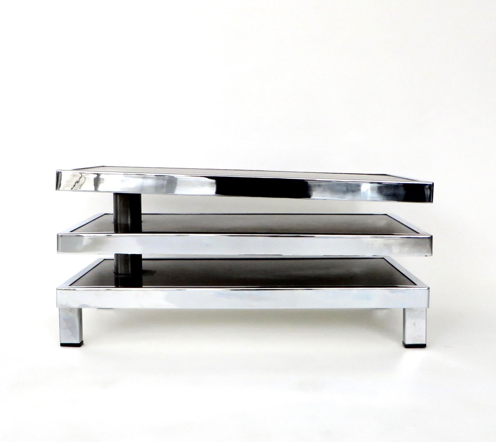 A French pivoting swivel three level stainless steel side table or coffee table by Freres Mercier, circa 1970.
The surface is matte or brushed stainless steel and has a polished stainless steel frame.
Some light scratches in top surface.
This