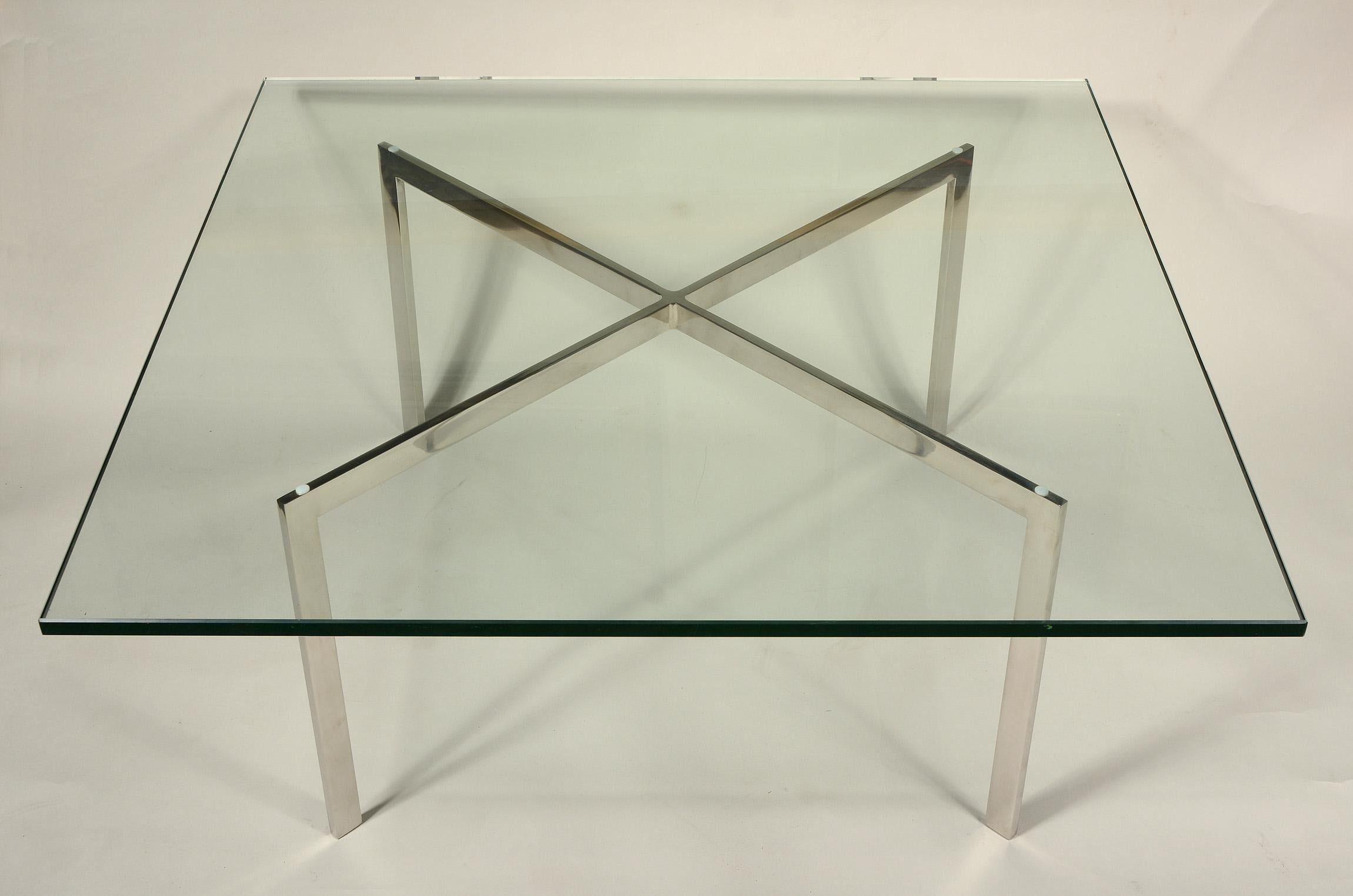 Older Barcelona table designed by Ludwig Mies Van Der Roe in 1929. This table was produces by Knoll and has a polished stainless steel frame. The frame is signed. The frame shows normal wear with a few small scuffs and scratches. The glass has some