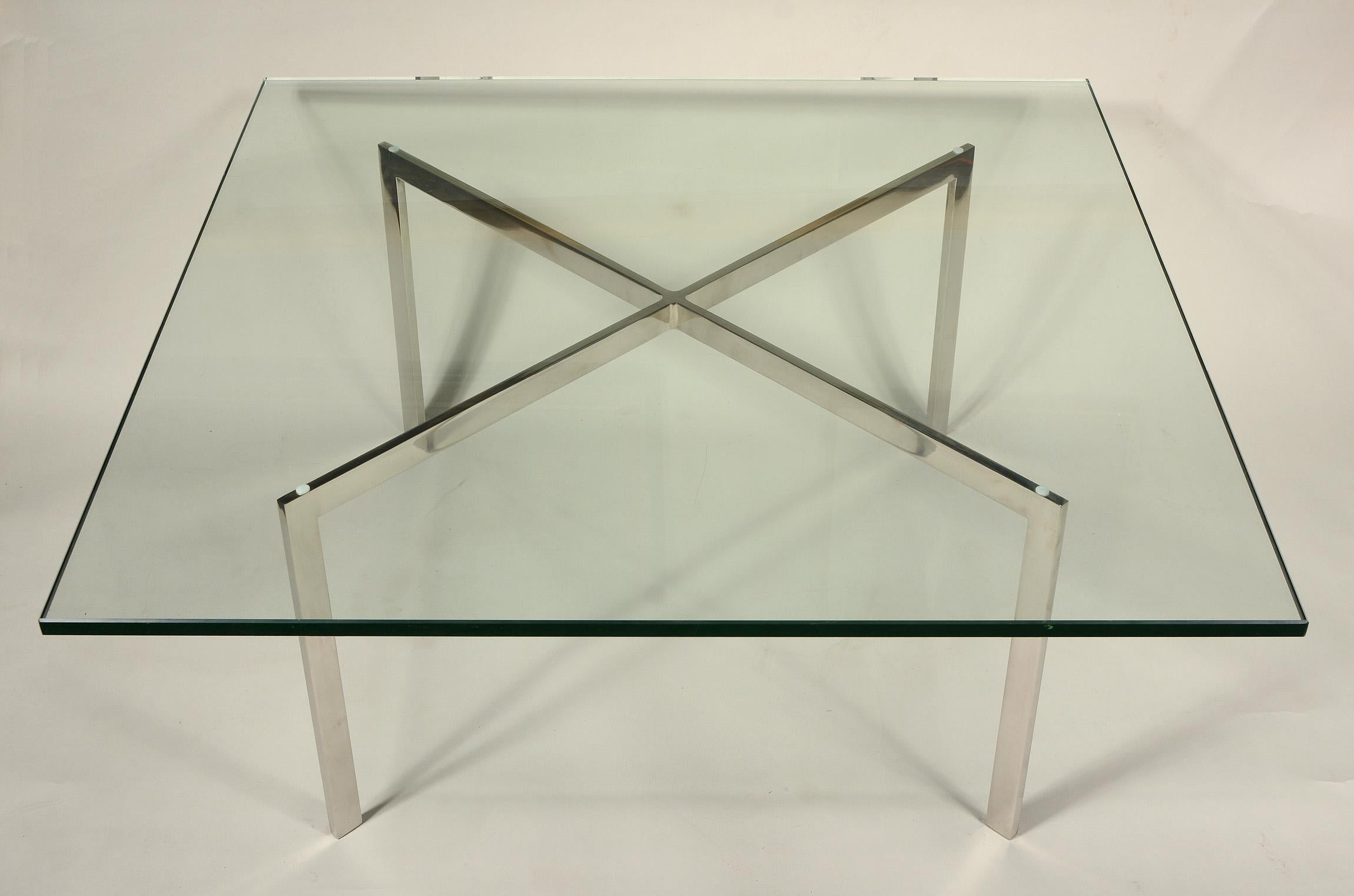 Older Barcelona table designed by Ludwig Mies Van Der Roe in 1929. This table was produced by Knoll and has a polished stainless steel frame. The frame is signed. The frame shows normal wear with a few small scuffs and scratches. The glass has some