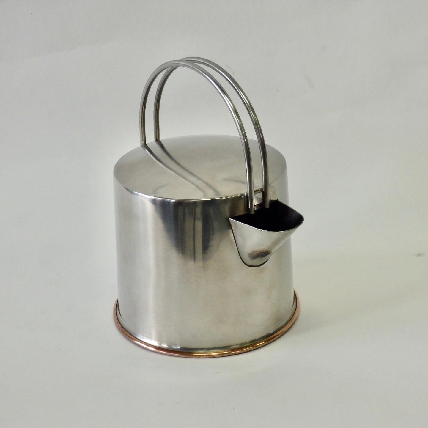 Stainless steel cylinder teapot with copper bottom. Designed by Ole Palsby. Shows wear .