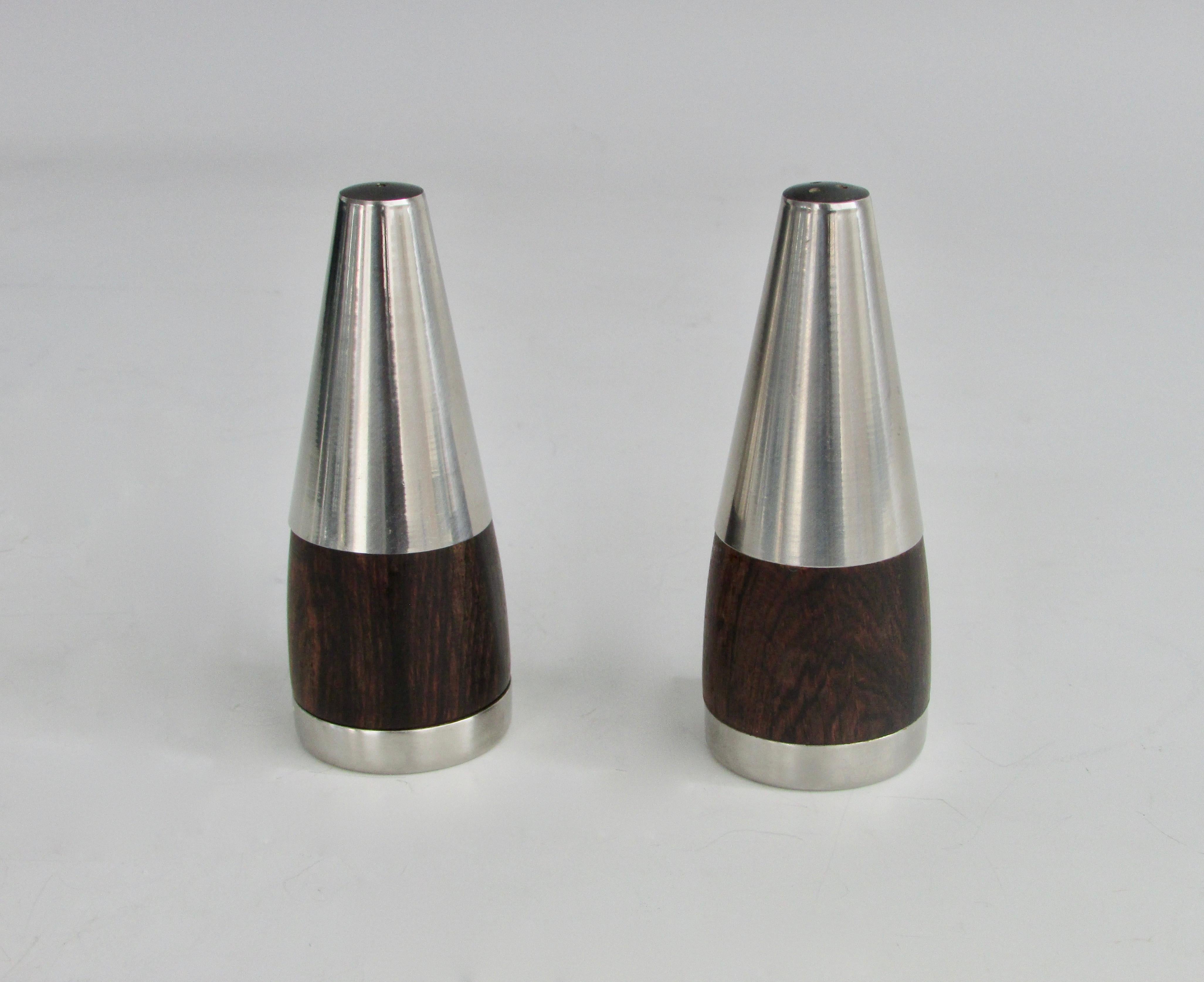Pair of Danish salt pepper shakers. Conical stainless steel tops sit on rosewood bodies. Retain original dried our Nade in Denmark stopper.