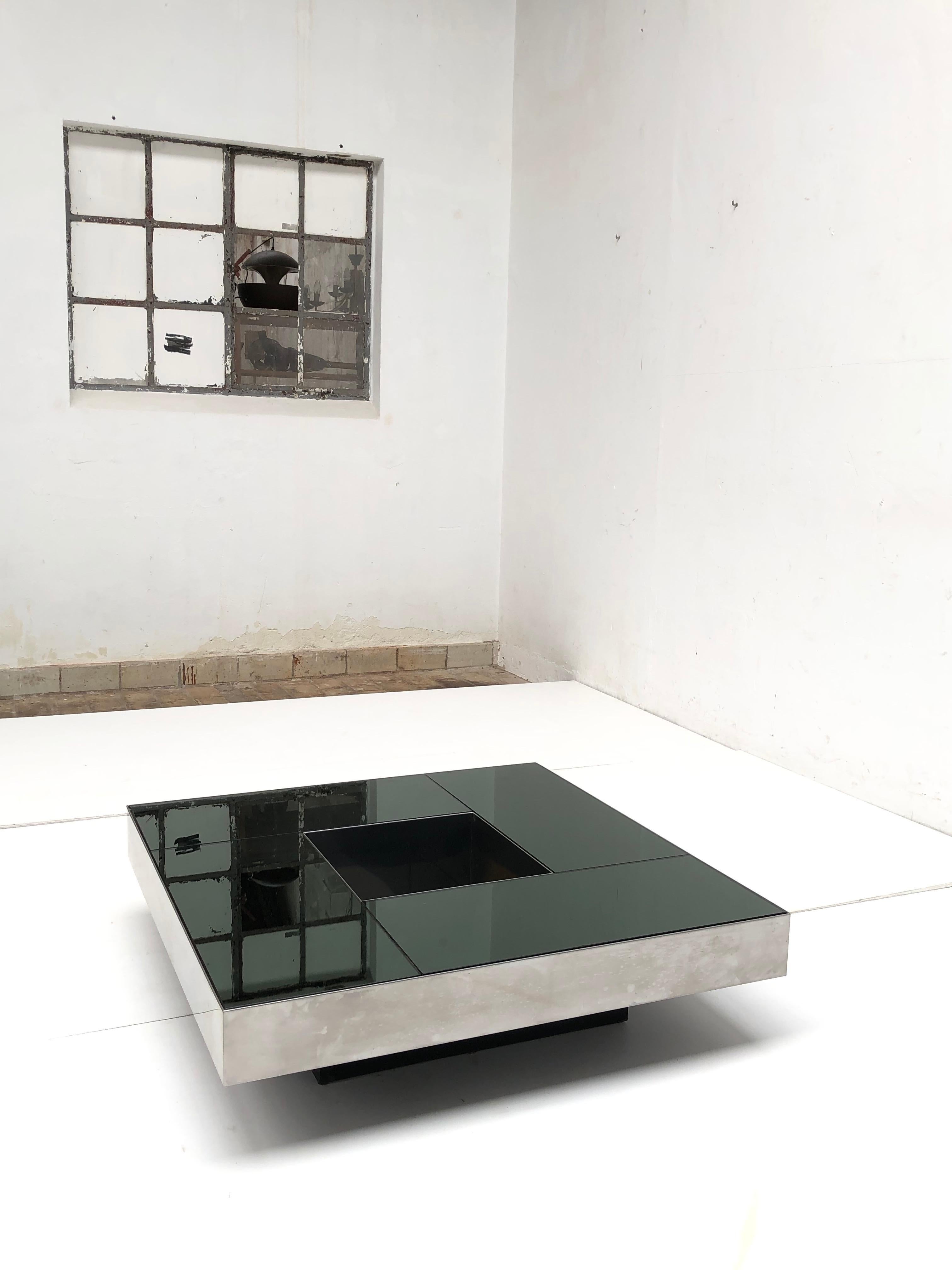 “Shillings” table by Italian designers Ausenda, Baldo Grossi and Gavioli

Produced in 1970 by NY FORM in Bologna Italy 

 Superb stainless steel table with smoked mirror top

Very Zen when you display a trailing plant or organic driftwood form