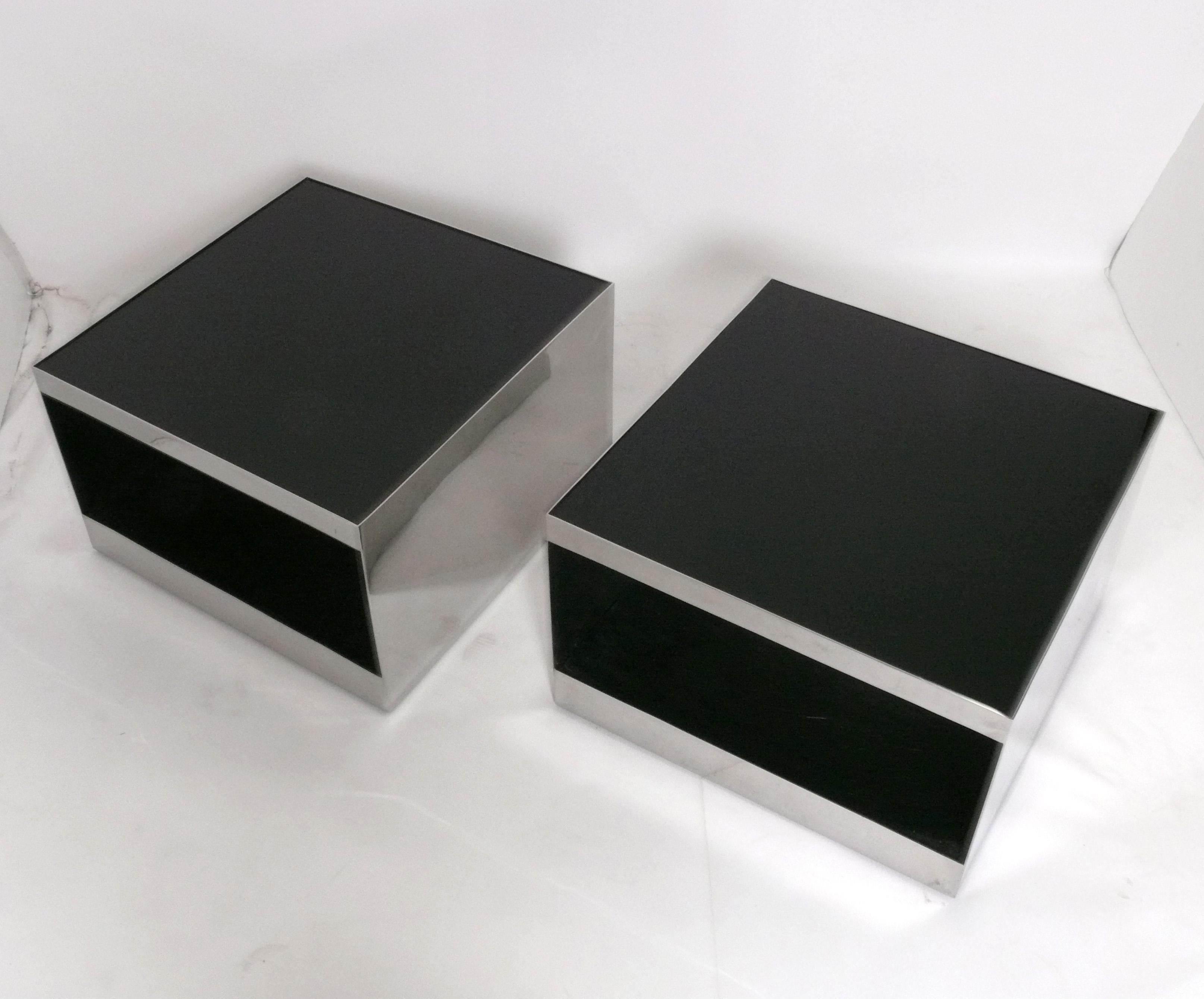 Pair of Sleek Stainless Steel and Black Glass Tables, designed by Joe D'Urso for Knoll, American, circa 1970s. They are a versatile size and can be used as coffee tables, end or side tables, or nightstands. They measure an impressive 27