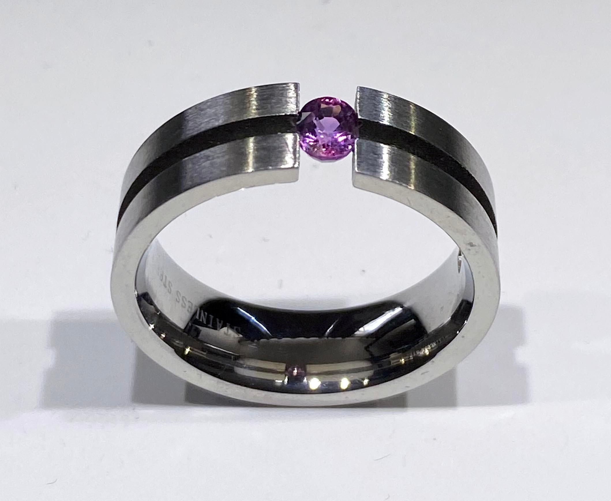 A Stainless Steel Tension Ring Set with an Oval Purple Sapphire.
This Stainless Steel Tension Ring is Set with a 0.33 Carat Oval Cut Natural Purple Sapphire of Sri Lankan Origin. The stone is held in place by the strength of the Stainless Steel Band
