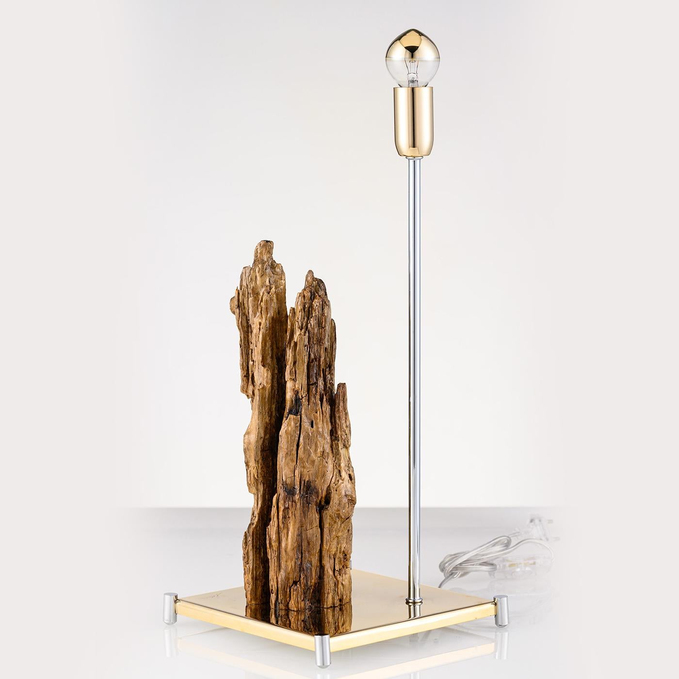 Featuring sea wood from the Amalfi Coast, the stunning Stalattite lighting sculpture, is both sophisticated and unique in design. Sitting atop a reflective gold stainless steel base with silver brass feet, the unique wood sculpture provides an